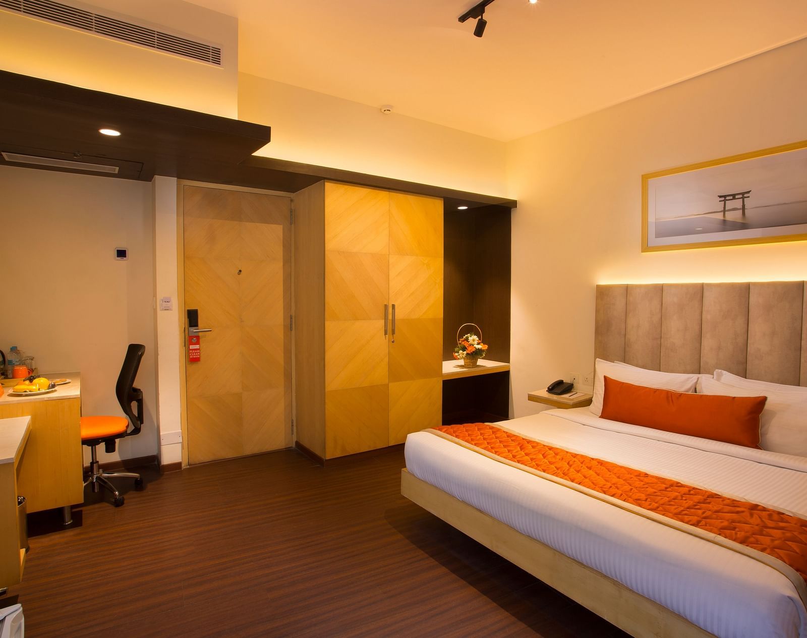 A spacious hotel room with a comfortable bed, ambient lighting and a television, featuring a wooden wardrobe and desk - Hotel Langford Keys by TGI, Shanti Nagar