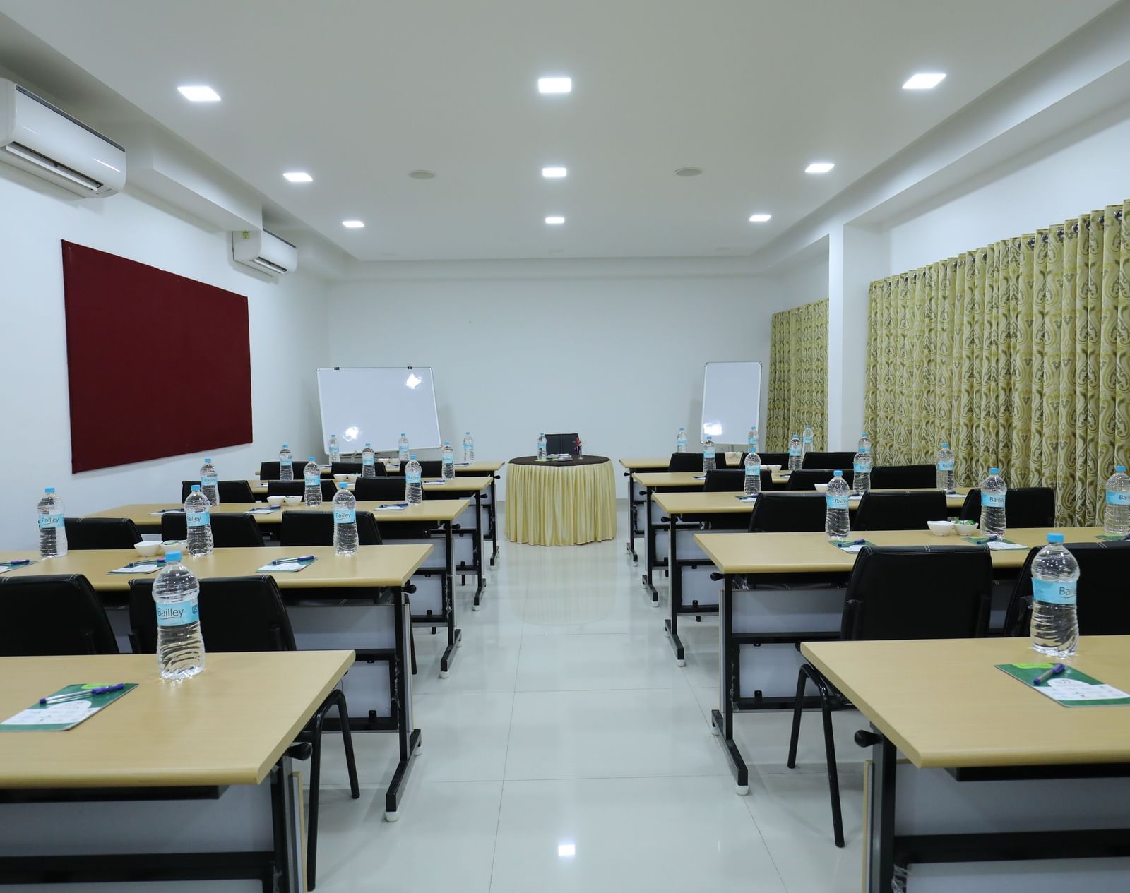 A classroom-style setup at Imperial Grande, with rows of tables and chairs facing a single table at one end of the room.