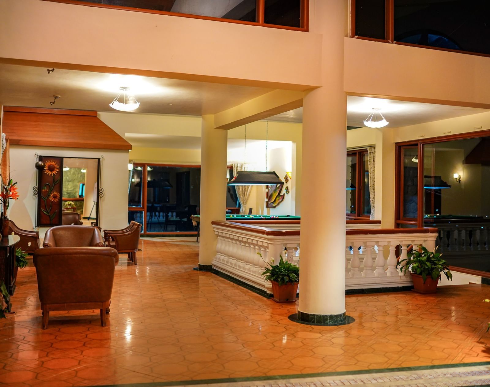 Corridor at La Montana By TGI with a sitting area and potted plants.