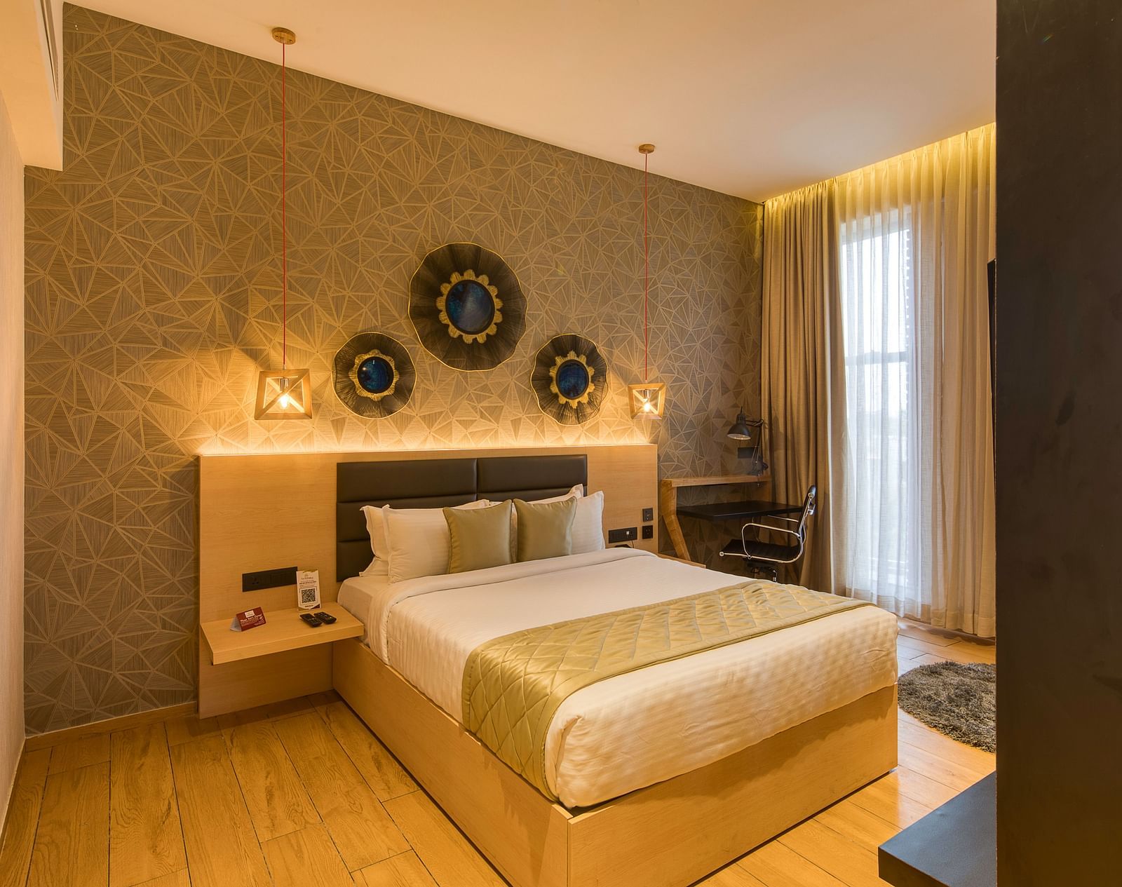 A double bed with golden bedsheets at Sumo Suite at Le Foliage by TGI, Bangalore