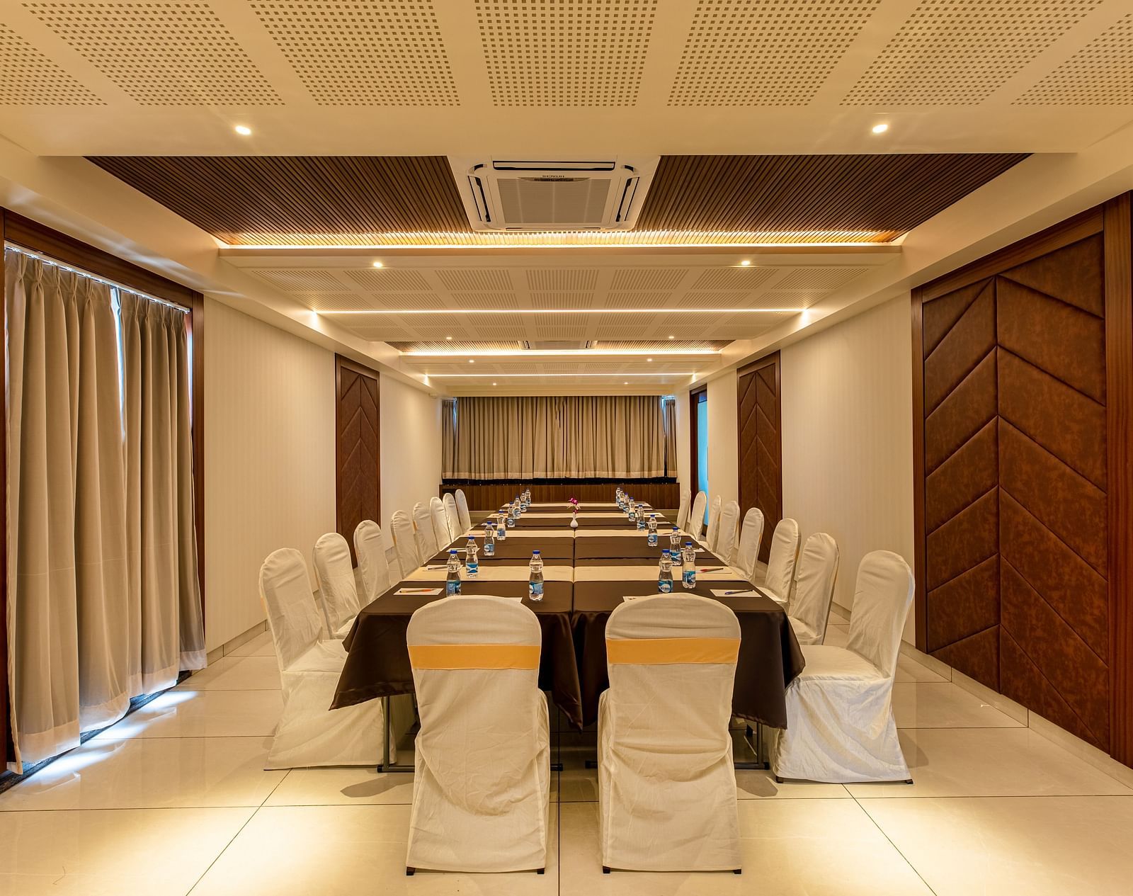 Image of a boardroom featuring a table surrounded by chairs at M Pro Palace.