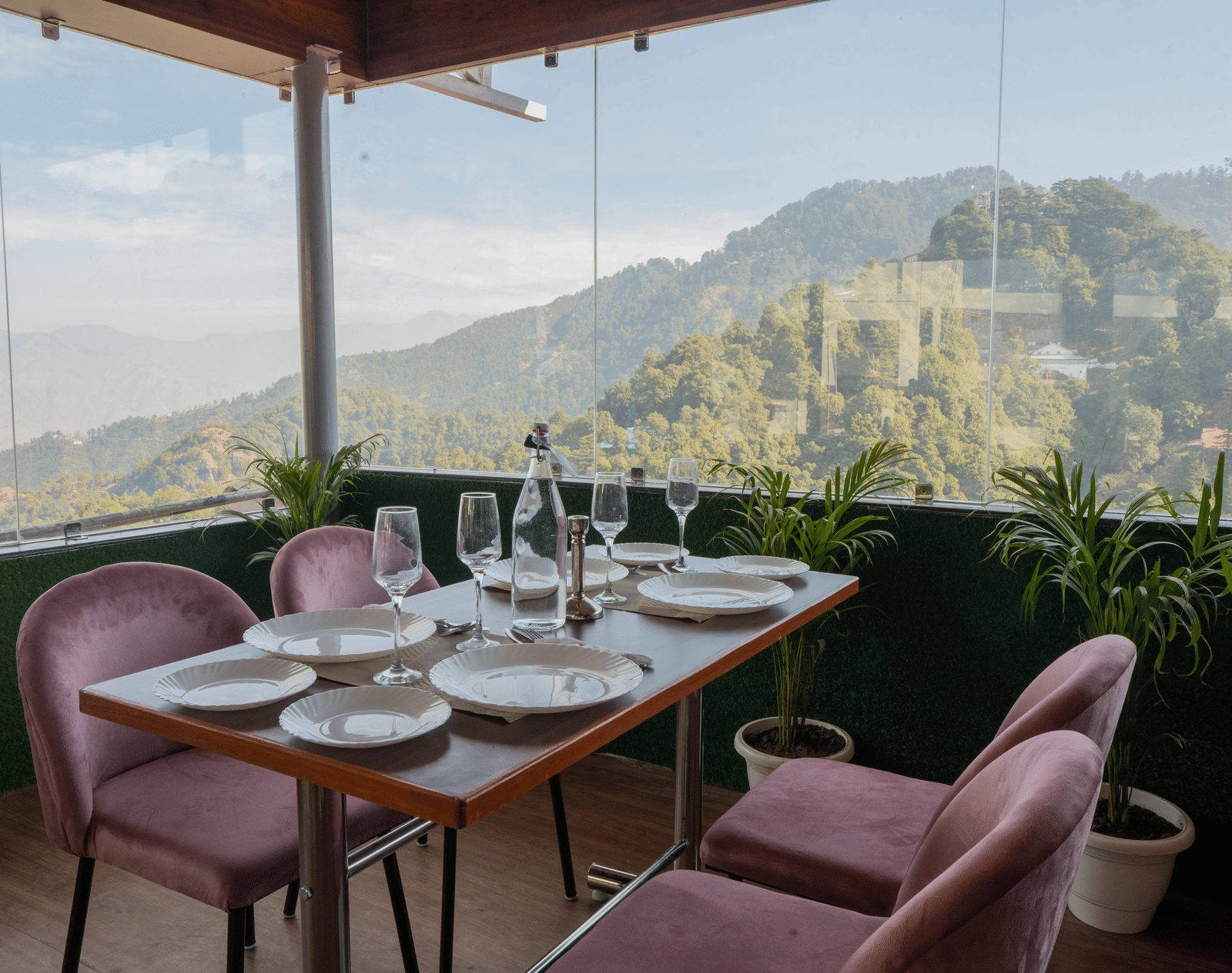 A dining setup with chairs and table facing mountain view at Perfectstayz Premium at Mall Road Hotel Super, Mussoorie.