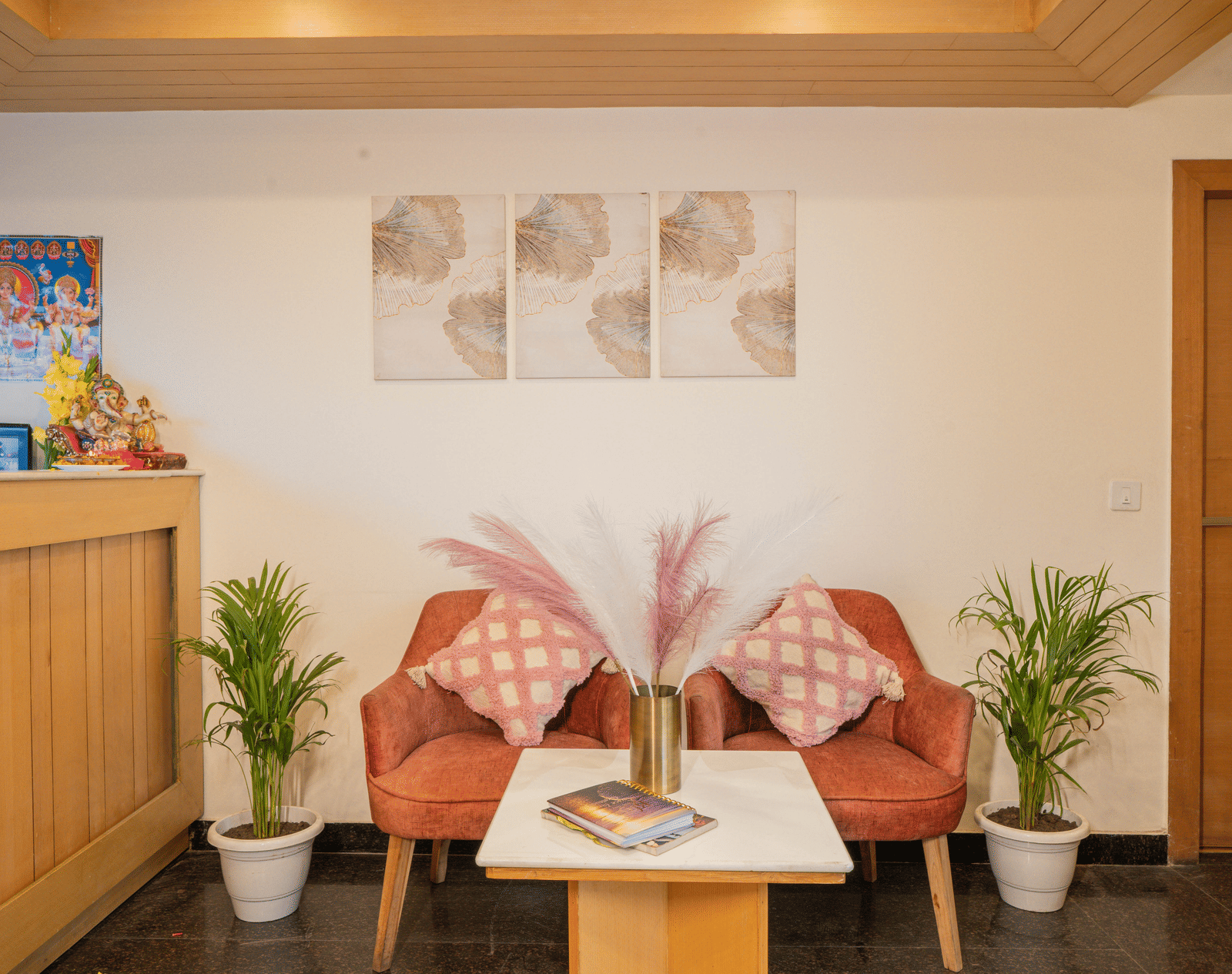 A seating area with chairs, table, and wall art at Perfectstayz Premium at Mall Road Hotel Super, Mussoorie.