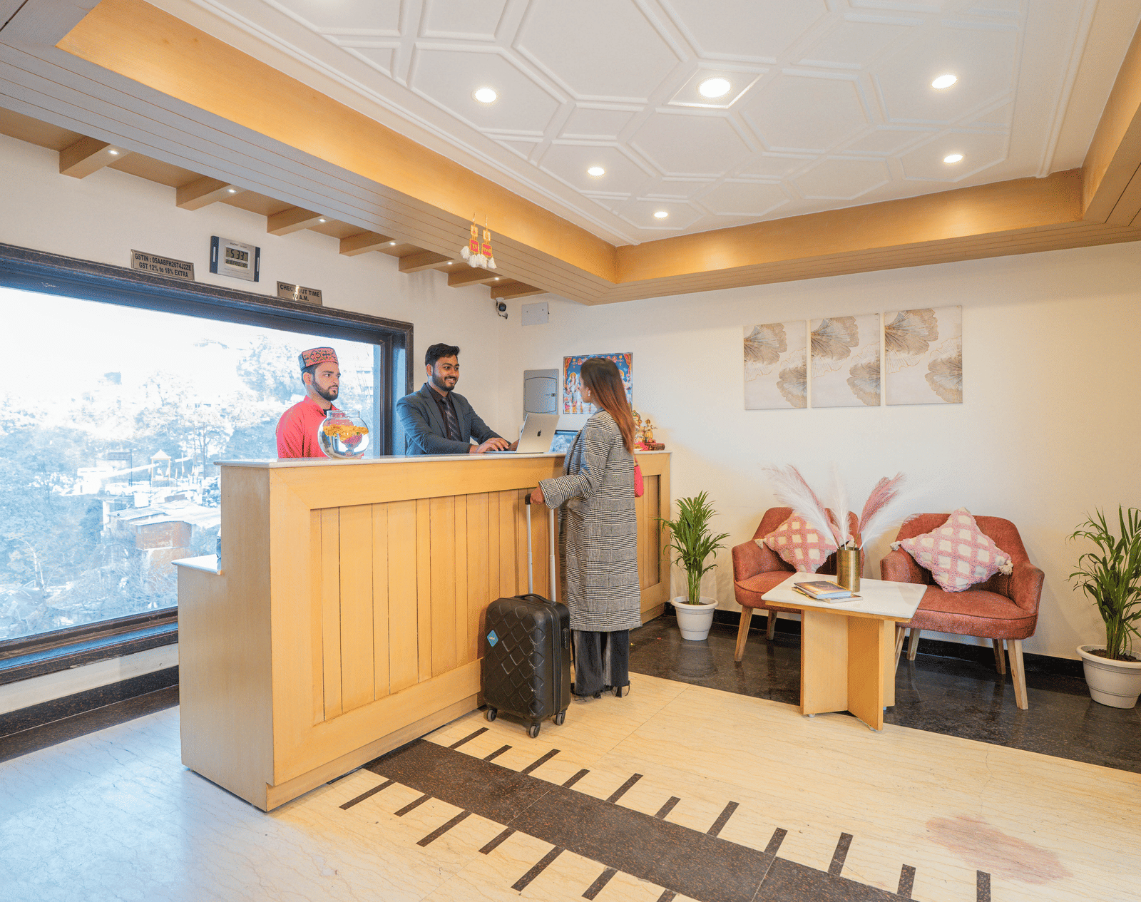 A hotel reception area with a desk and seating at Perfectstayz Premium at Mall Road Hotel Super, Mussoorie.