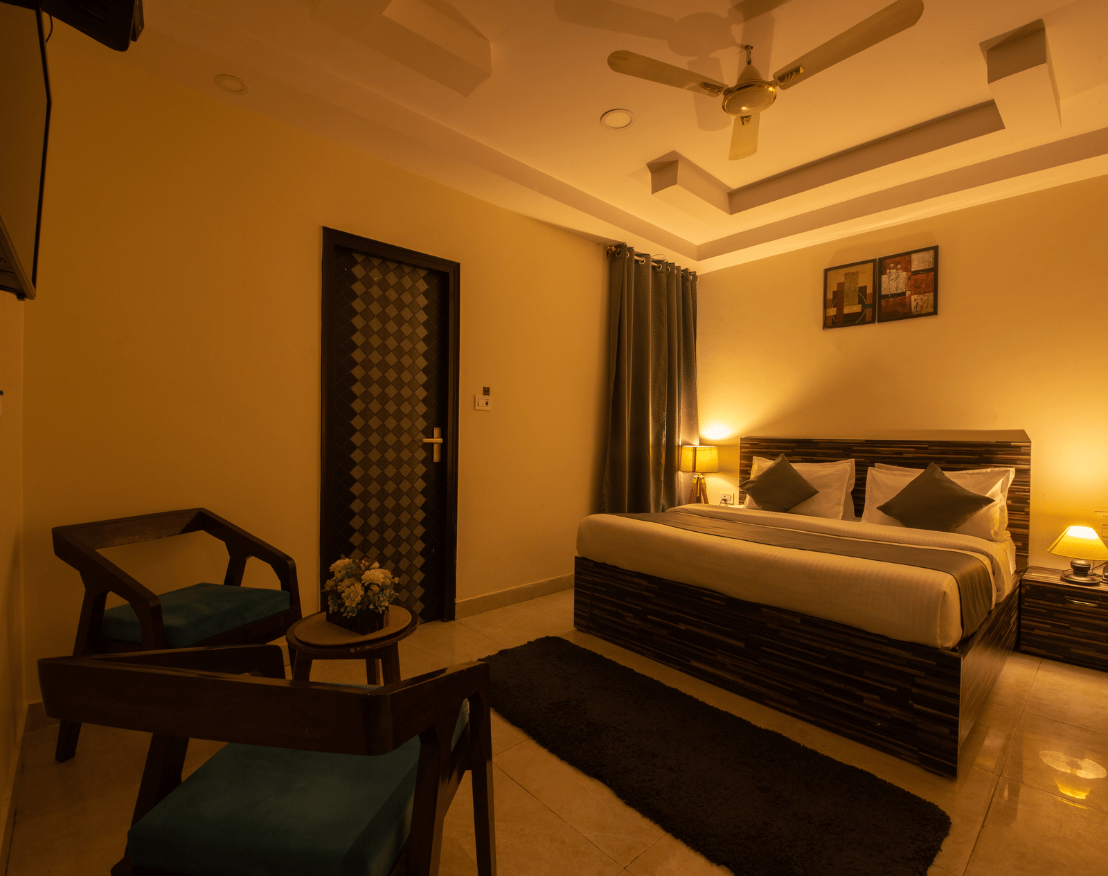 Spacious hotel room with ambient lighting and seating area - Perfectstayz Value Umra Grace, Haridwar