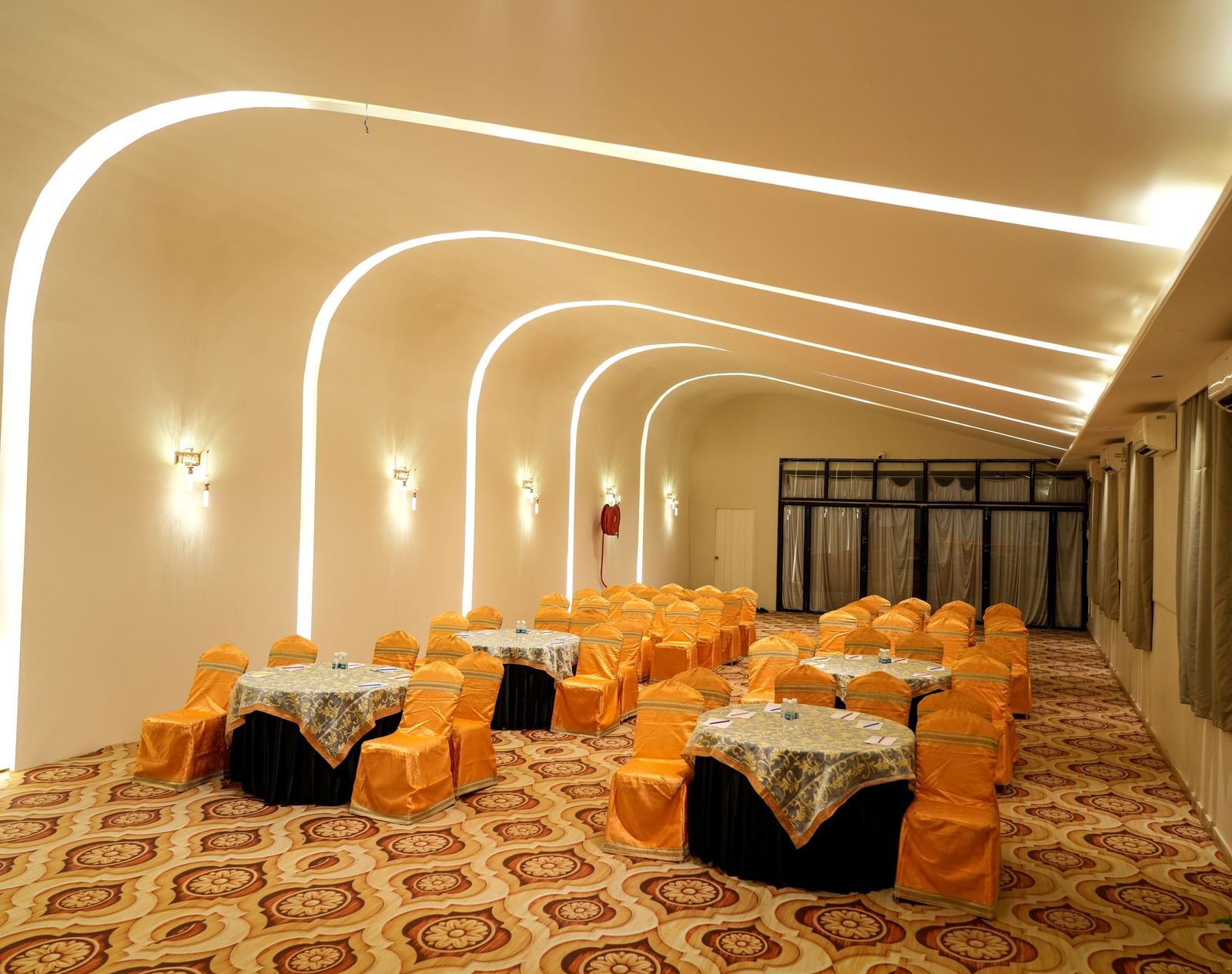 Elegant dining area with warm lighting and stylish seating at Pravasa Hotel Kolhapur.
