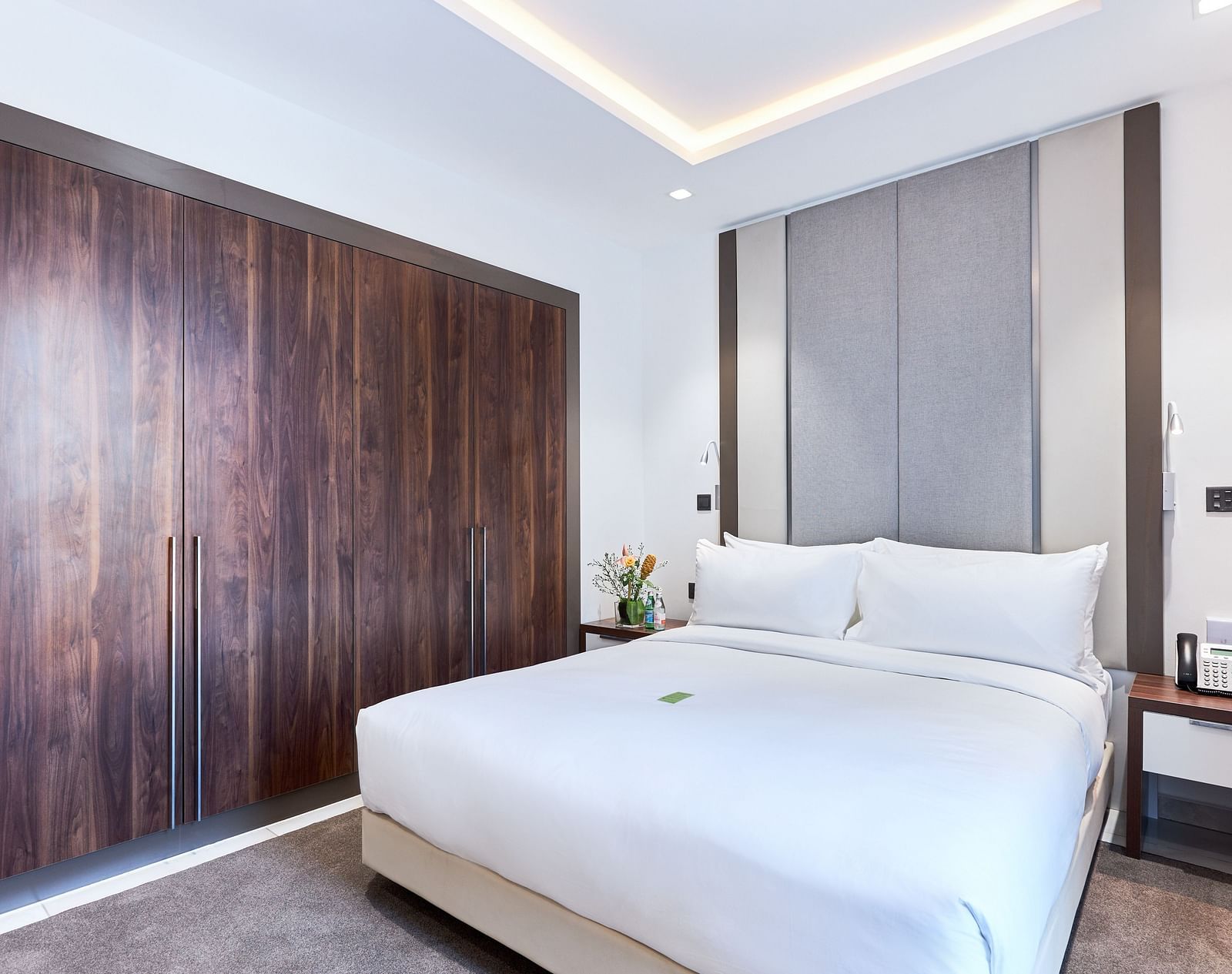 A large bed next to a wardrobe in Executive Suite at The Pelican Hotel, Accra.