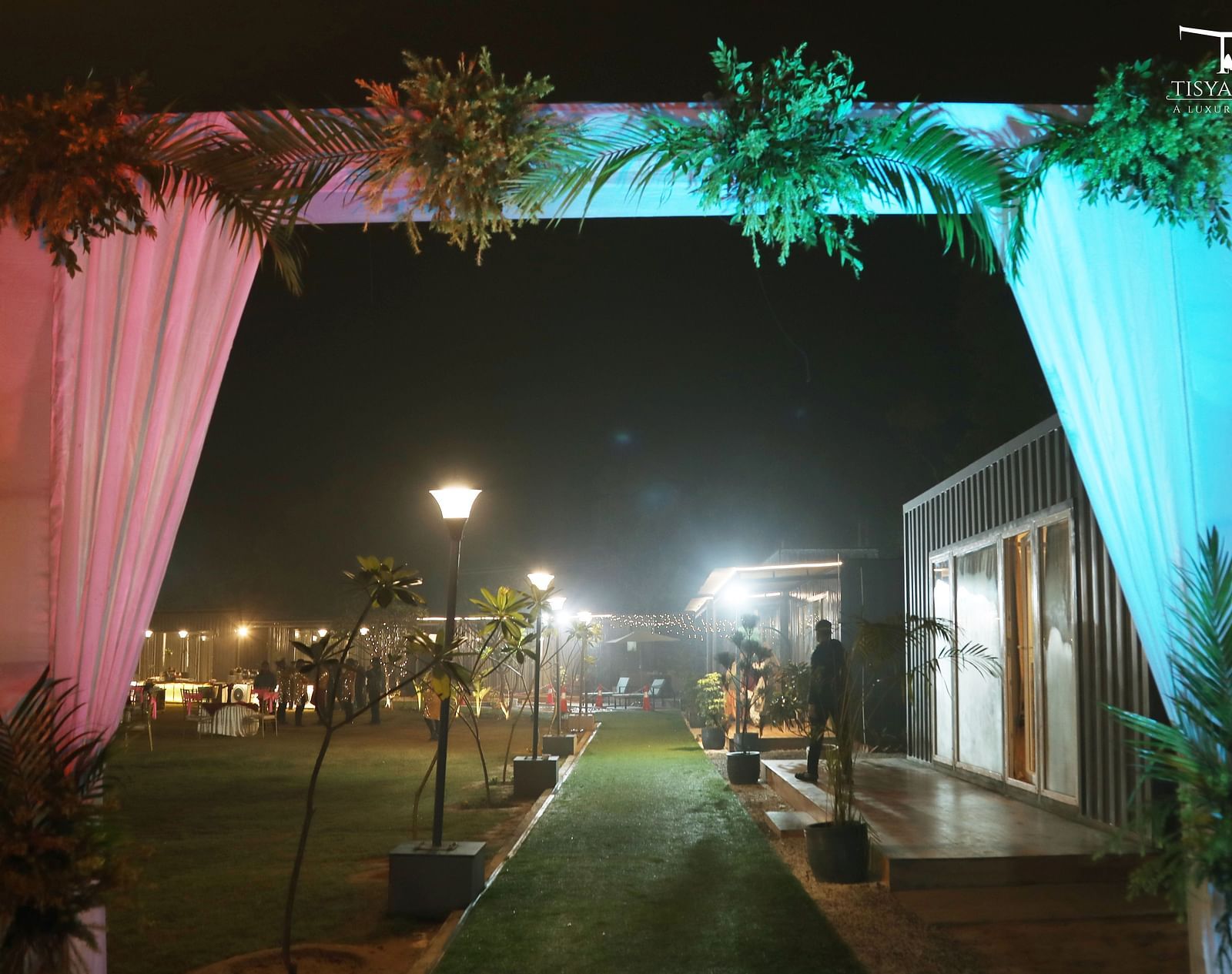 Walkway with draped fabric and lighting at night at Tisya Farms, Gurgaon.