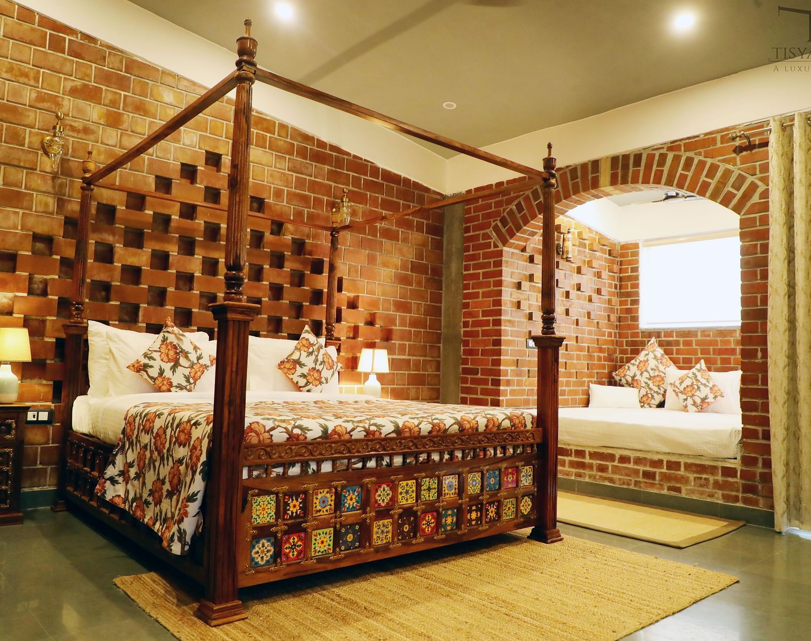 A bedroom with a bay window bed and a lamp beside it at Tisya Farms, Gurgaon.