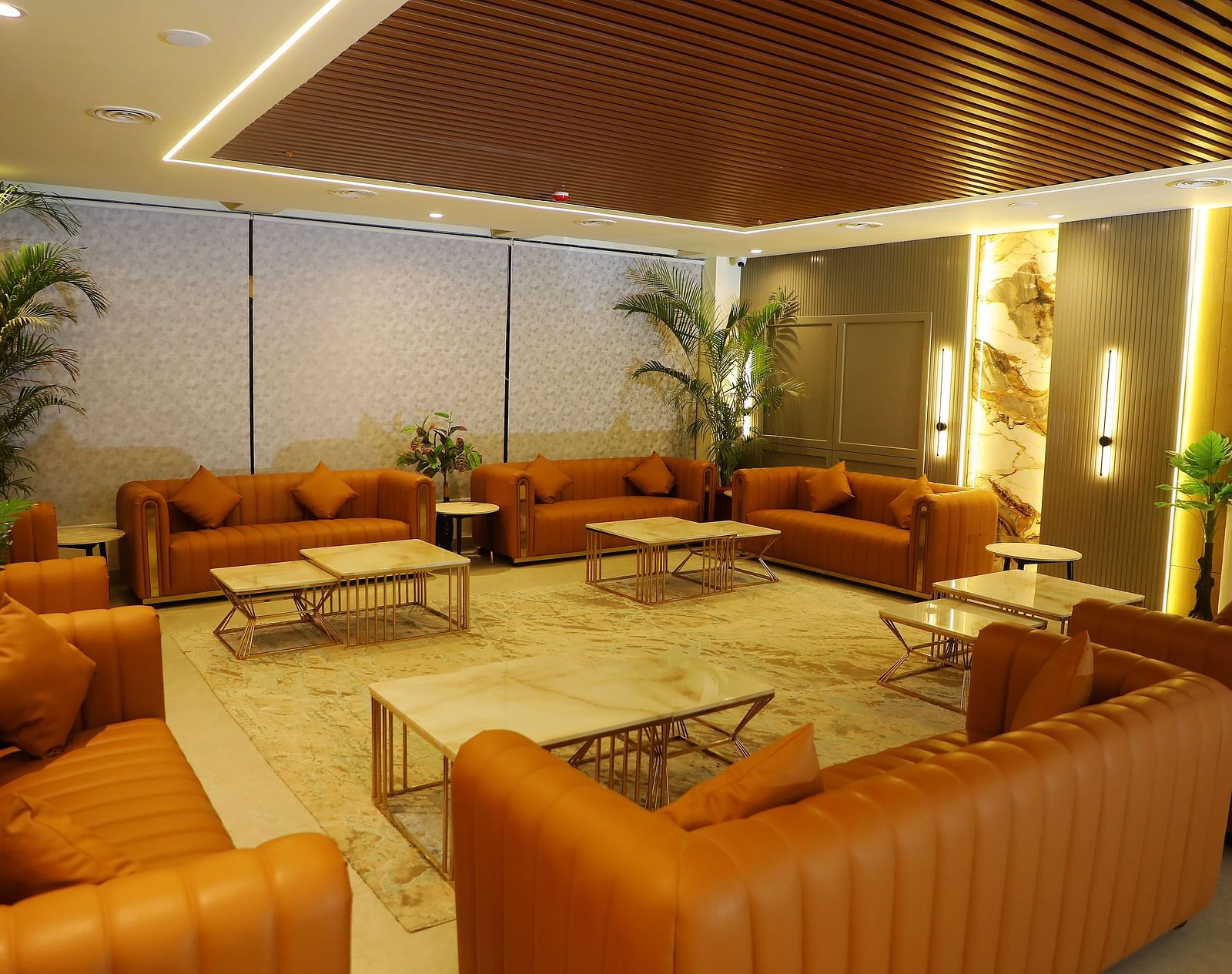 Elegant guest lounge at Town Square Suites with plush sofas and warm lighting