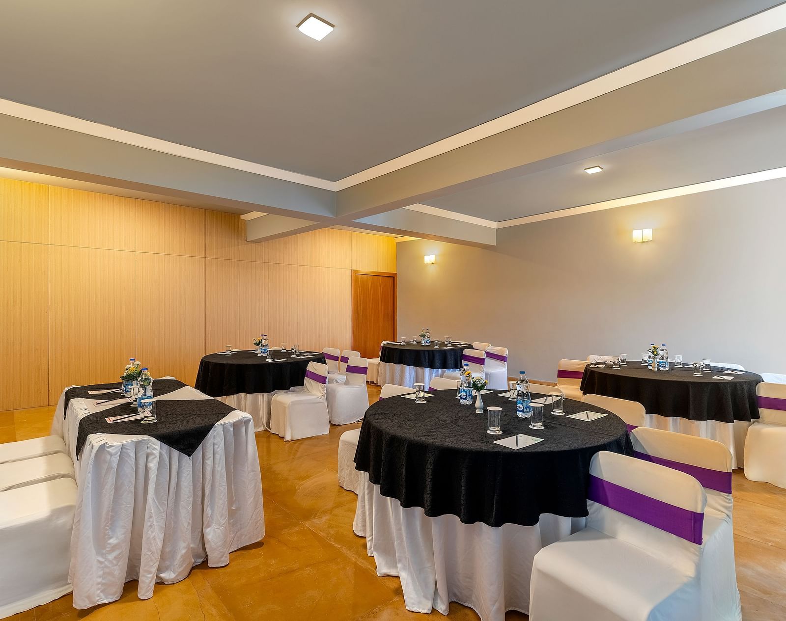 A room with round tables set with linens and chairs, prepared for an event - Via Lakhela Resort & Spa, Kumbhalgarh