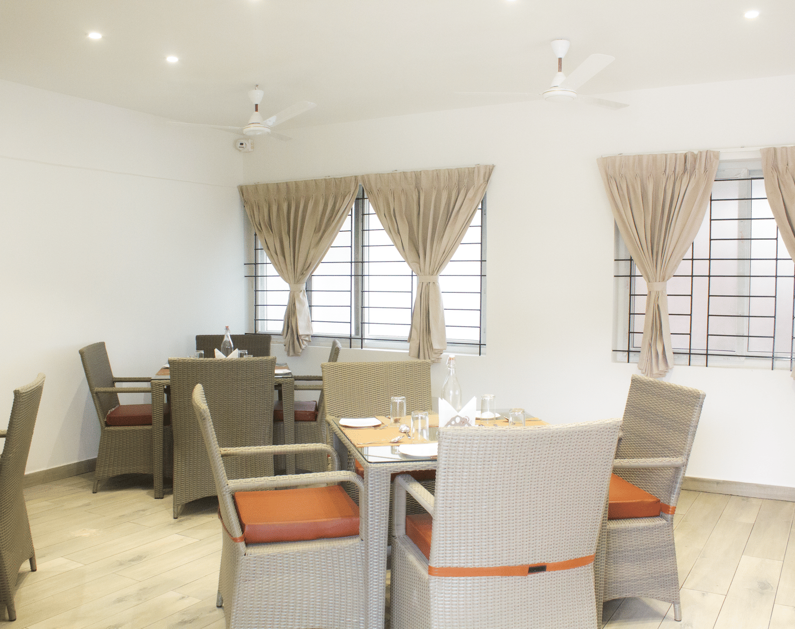 A full-view shot of the Spice and Slice Restaurant with well-arranged dining tables at WOW Naturefull Resorts, Yercaud.