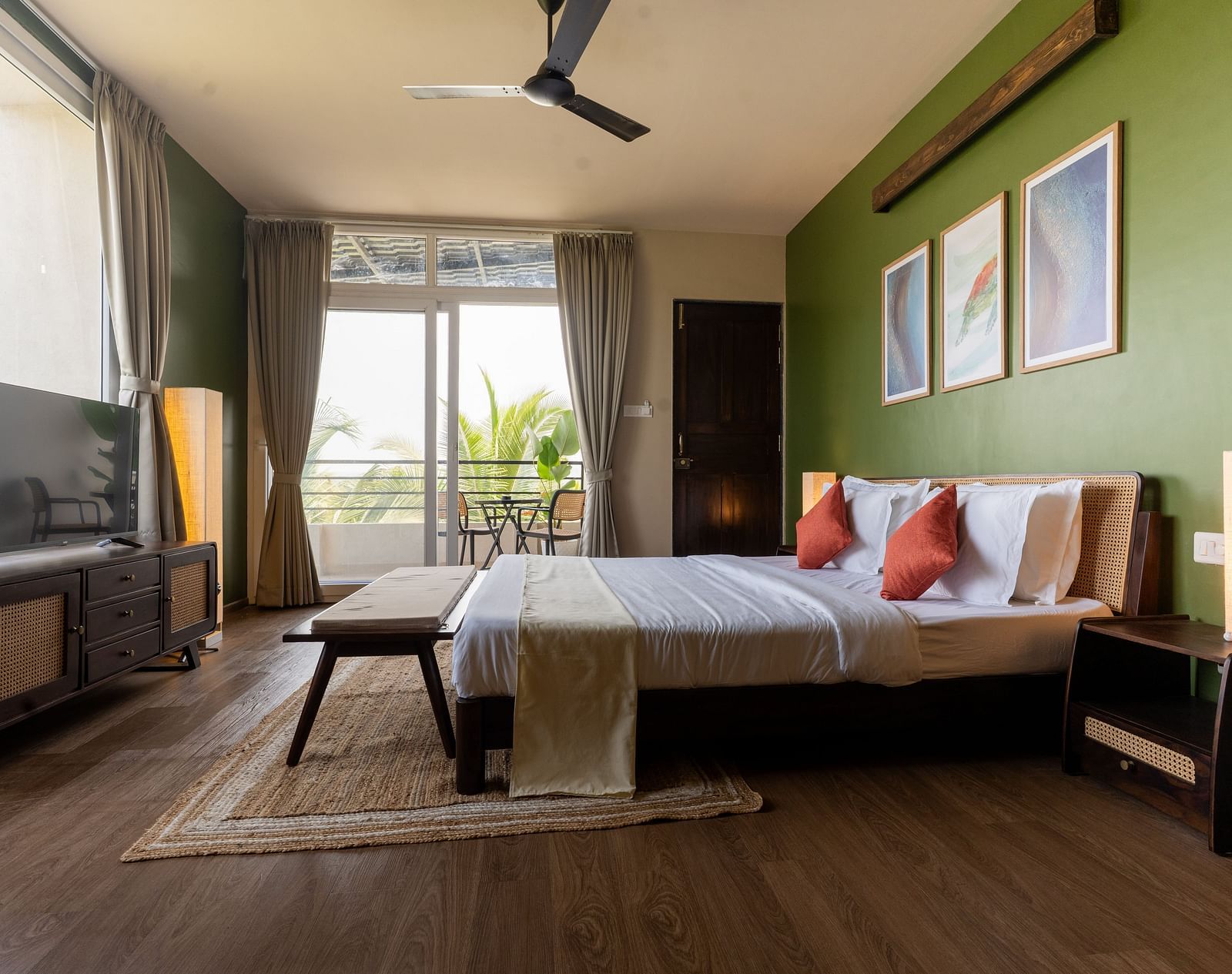 Spacious bedroom with natural lighting, modern decor, and a cosy seating area at Kssemya.