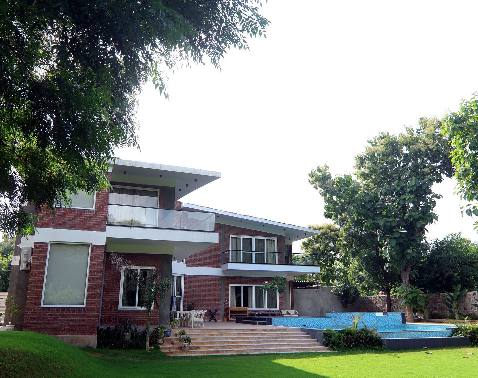 A scenic view of Tisya Farms with a large tree standing majestically beside it.