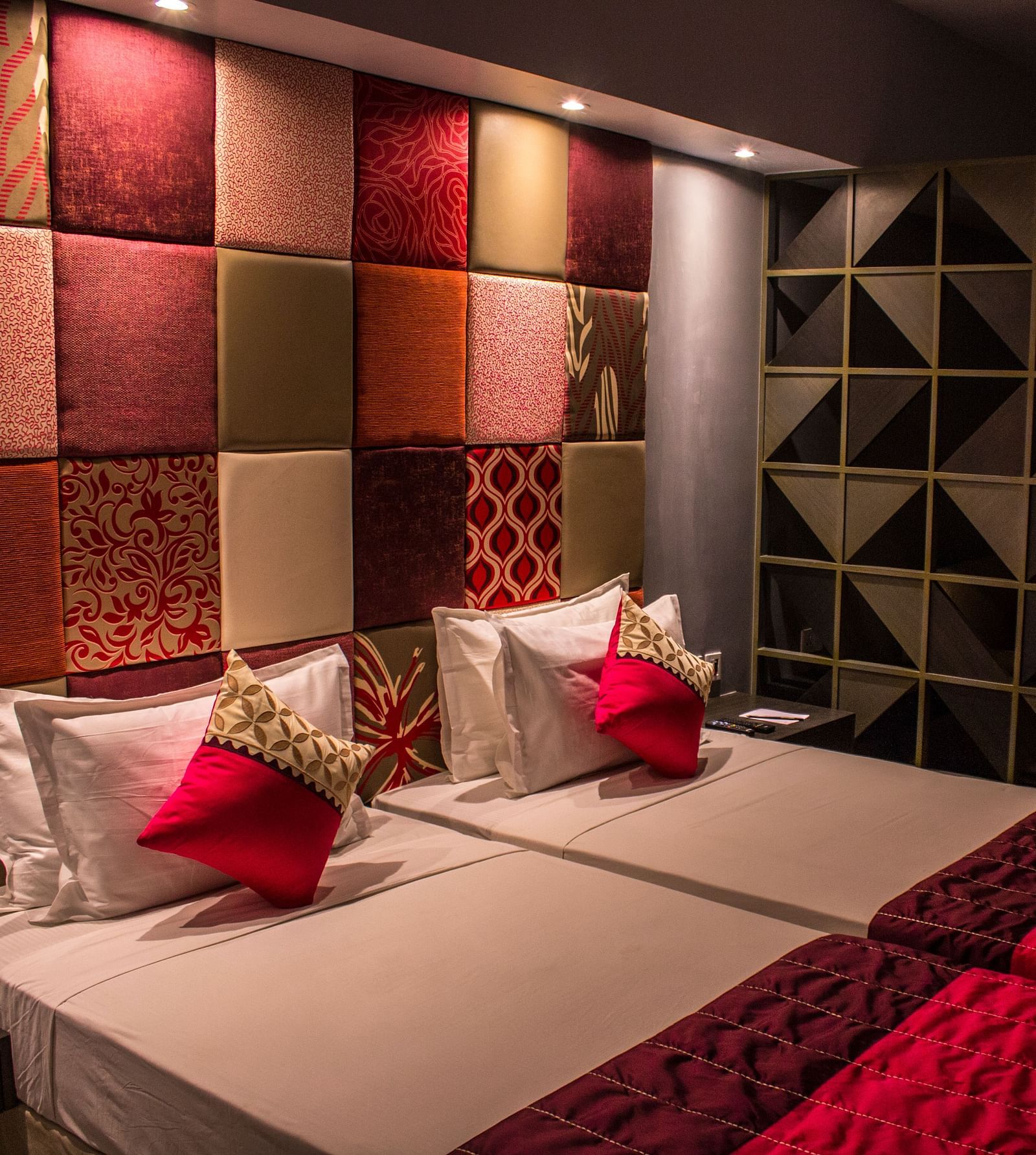 A room with twin beds and  pillows arranged on it  | Regency Tirunelveli By GRT Hotels