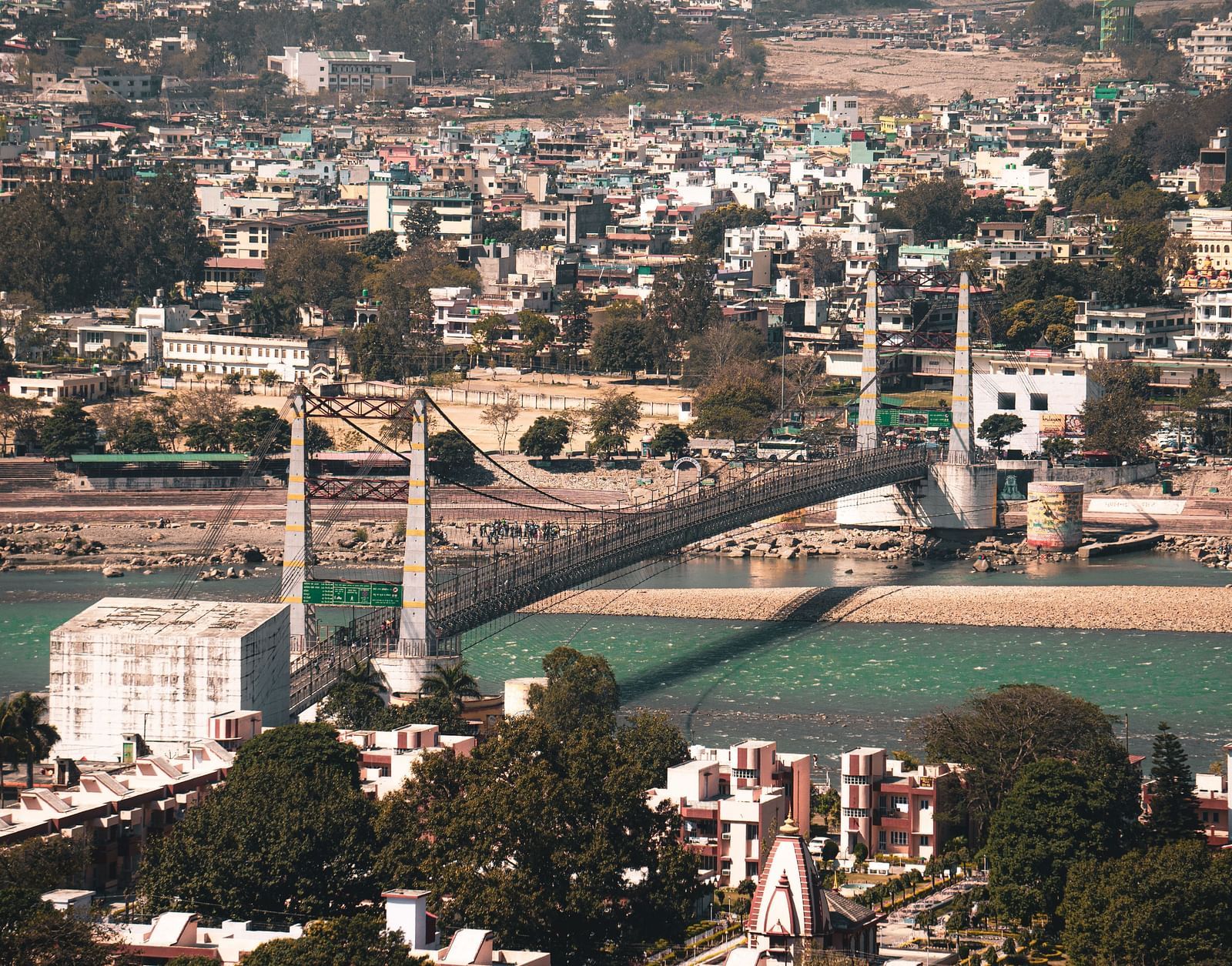 a view of a bridge connecting two different islands separated by a river