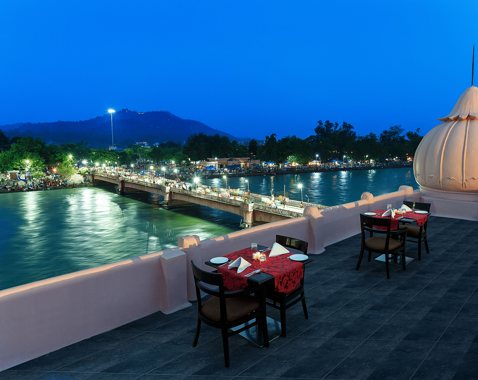 Image of rooftop restaurant with dining setup and a pool