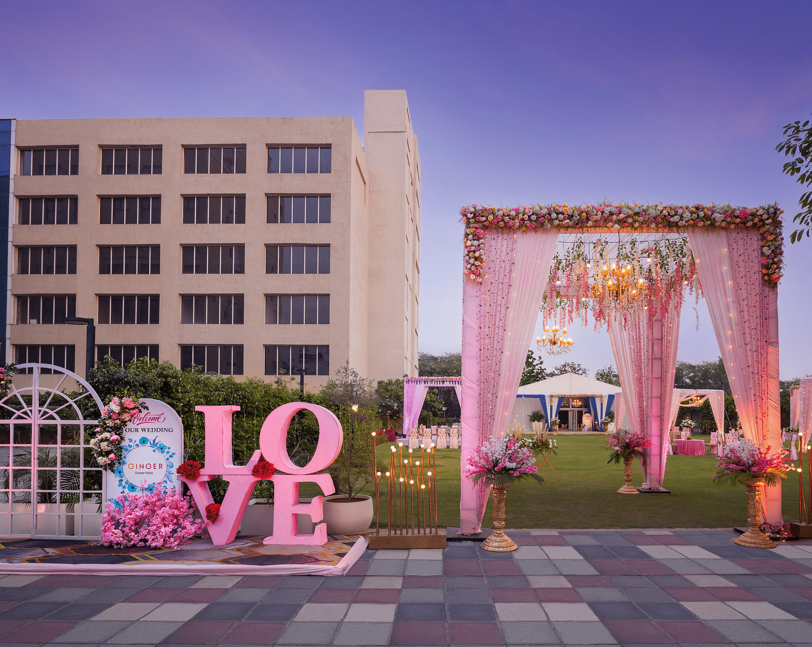 an entrance to an event space with a canopy as the entry and Love written with large letters - The Hideaway Banquets & Lawns, Greater Noida