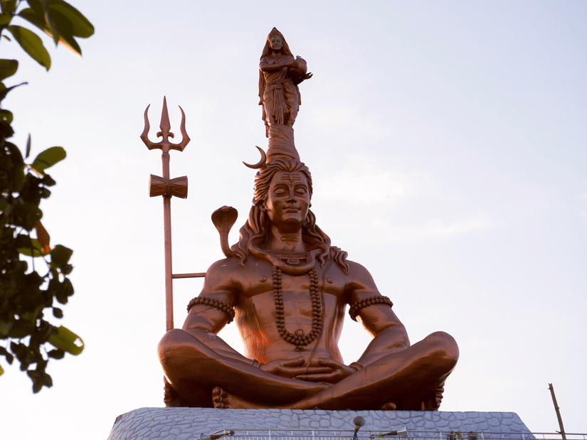 A wide view of a bronze statue of shiva.