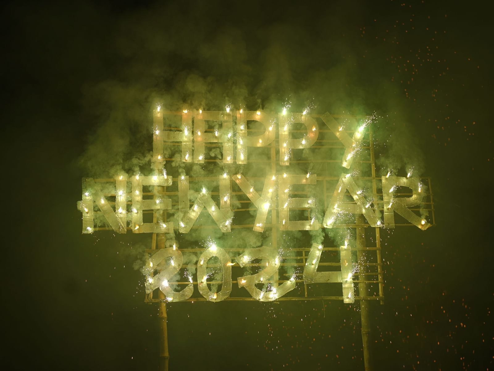 A  sign 'HAPPY NEW YEAR 2024' against a dark background, creating a festive display | Vedic Village Spa Resort, Kolkata