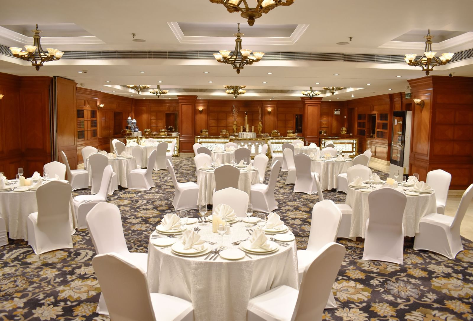 Conference hall set up in a U-shape with white-covered chairs at Accord Metropolitan.