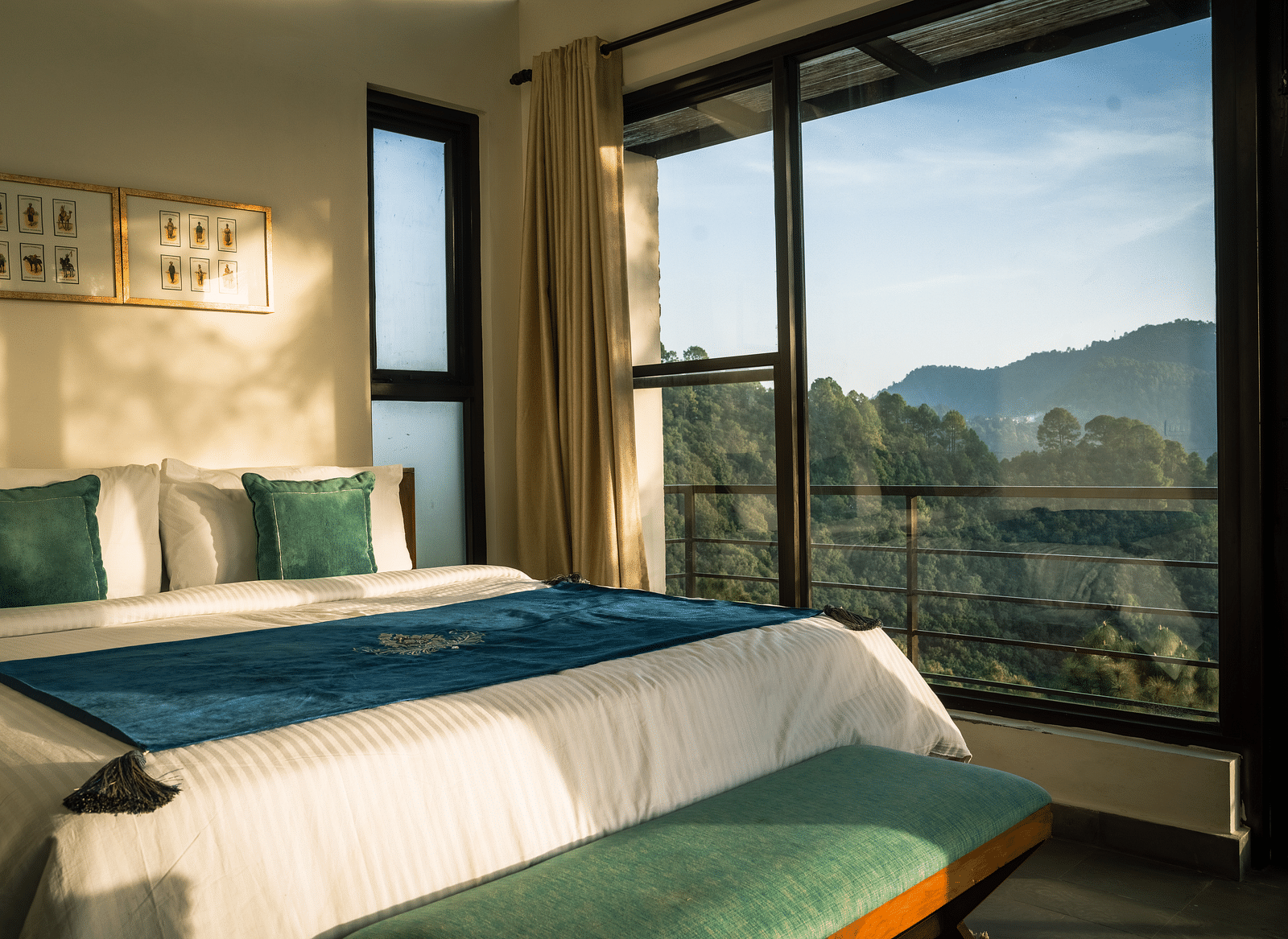 A bedroom with a balcony offering a mountain view and sunlight streaming in at BluSalzz Escapade Resort, Lansdowne