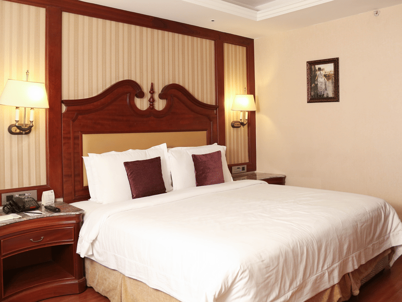 Cosy room with king size bed and modern interiors atstay stay rooms at hablis hotel, chennai.