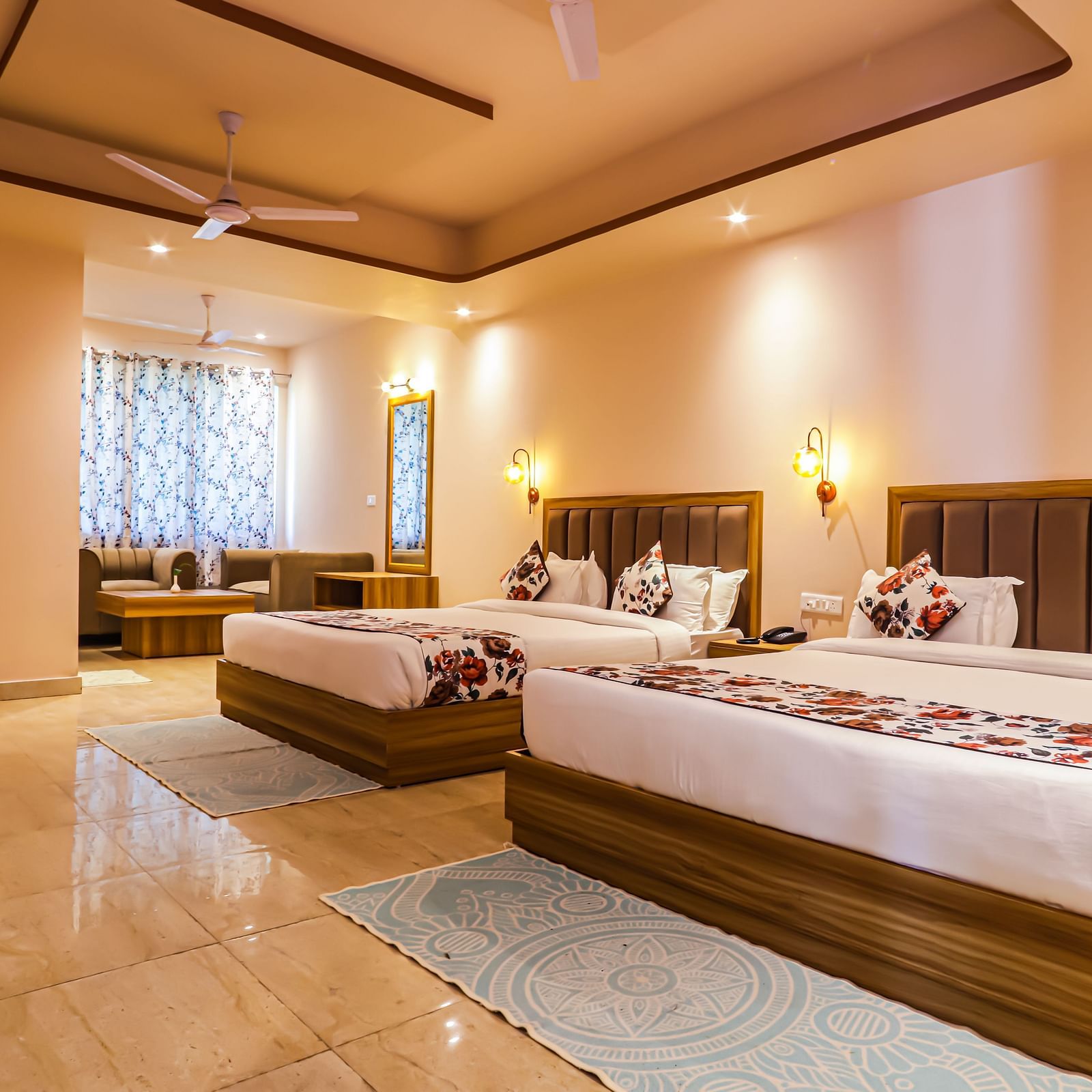 A comfortable bedroom at Vedikant Resorts The Mallard Corbett offers beds, a seating arrangement, and warm lighting.