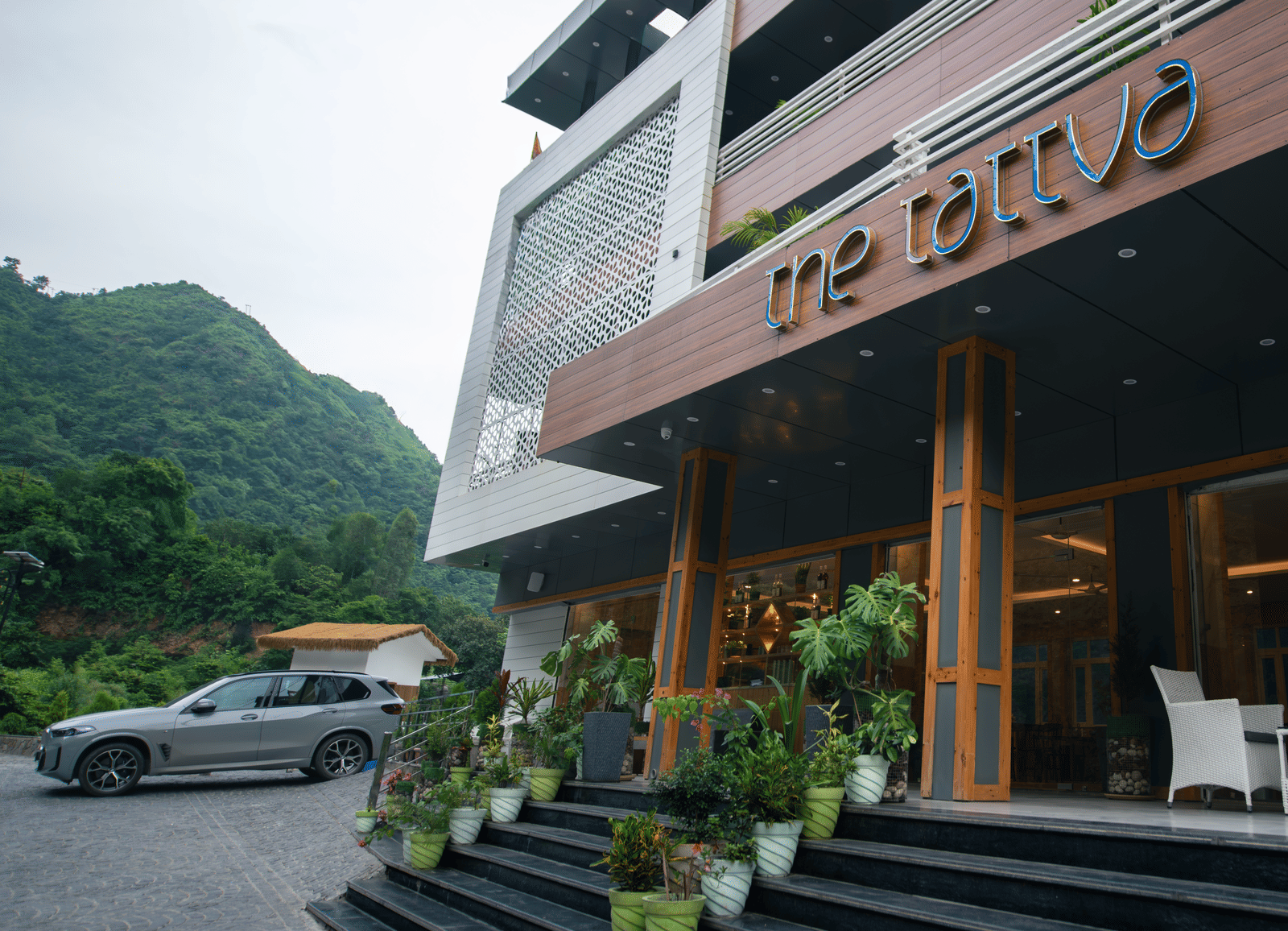 Facade of The Tattva Devaprayag featuring the entrance and parking space.