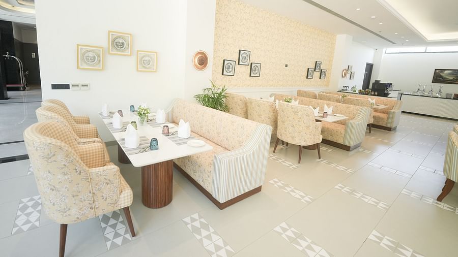 An image of the restaurant dining area at our hotel, featuring upholstered chairs and sofas used for dining - NAMAMI BY ZENQ BANKHANDI