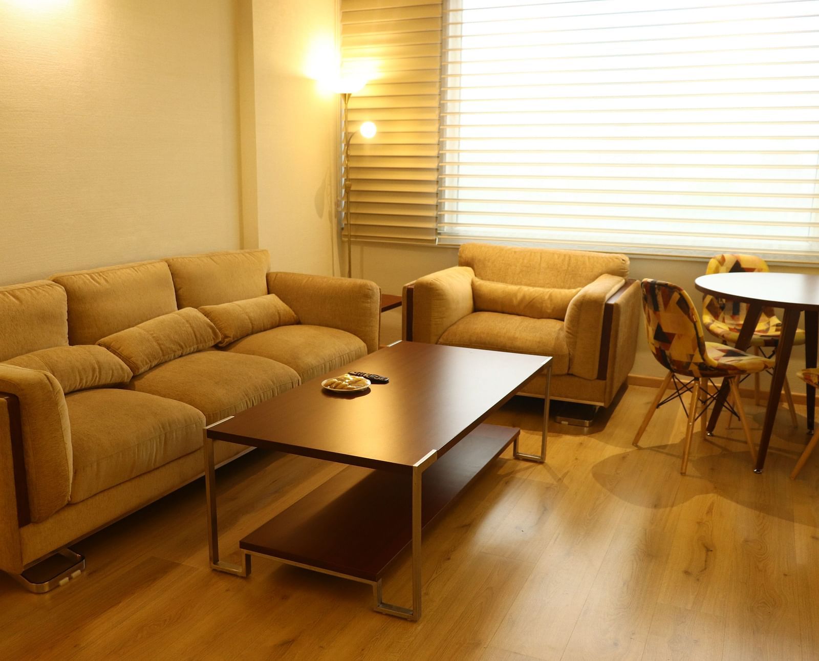 A living area featuring a sofa set, coffee table, and dining setup | Gemini Continental