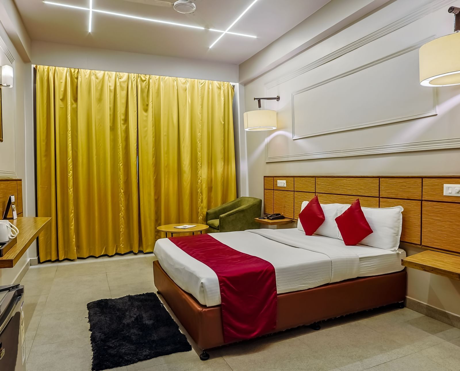 Room with bright curtains and double bed at Max Hotel Prayagraj.