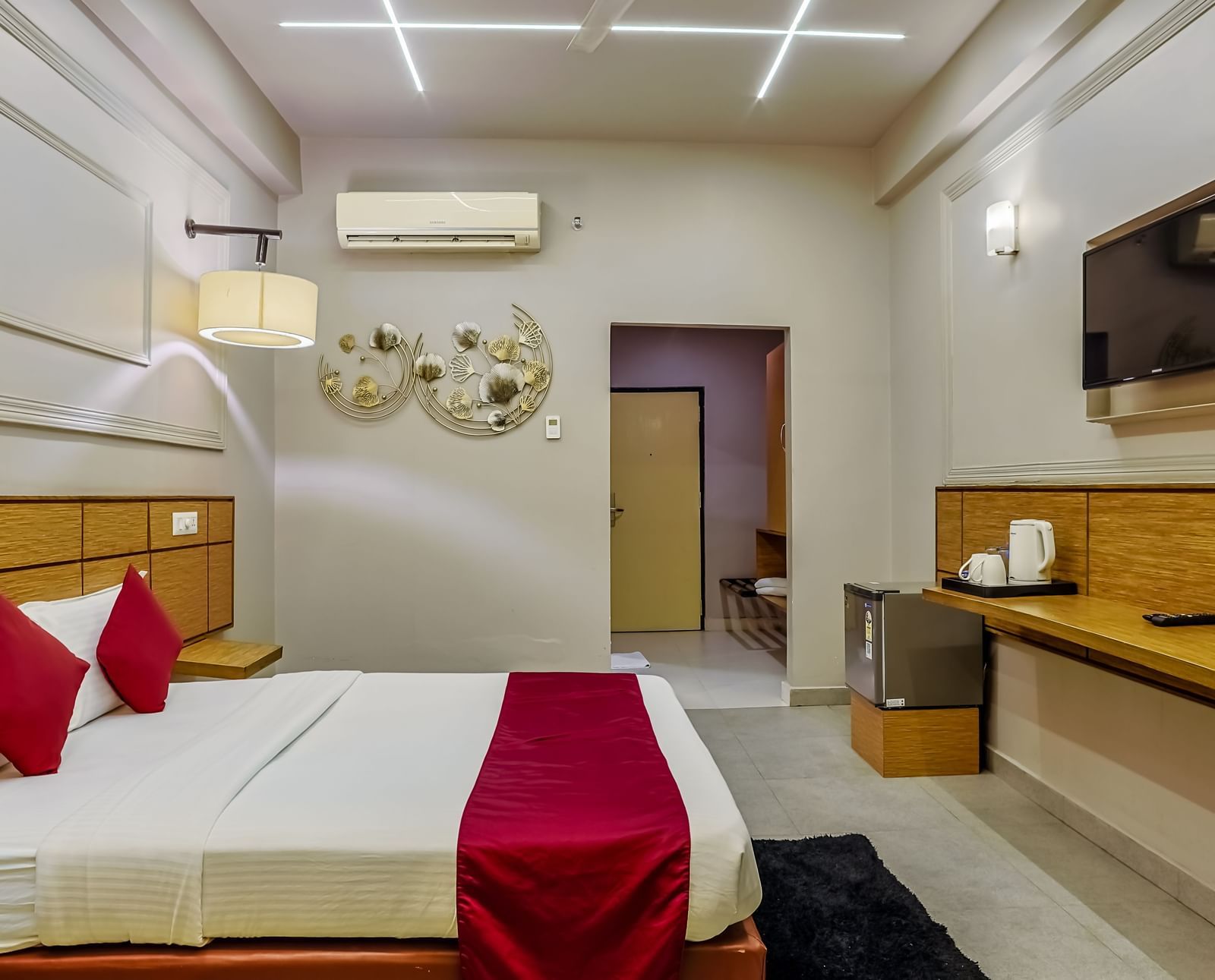 Tidy room with side table and modern amenities at Max Hotel Prayagraj.