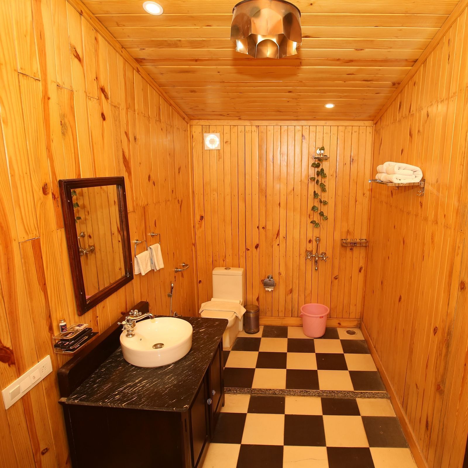 Kashmir Cottage Villa's Pool Room featuring a spacious washroom with wooden-style flooring, a modern sink, and a wall-mounted mirror at Aanandam Resort & Spa