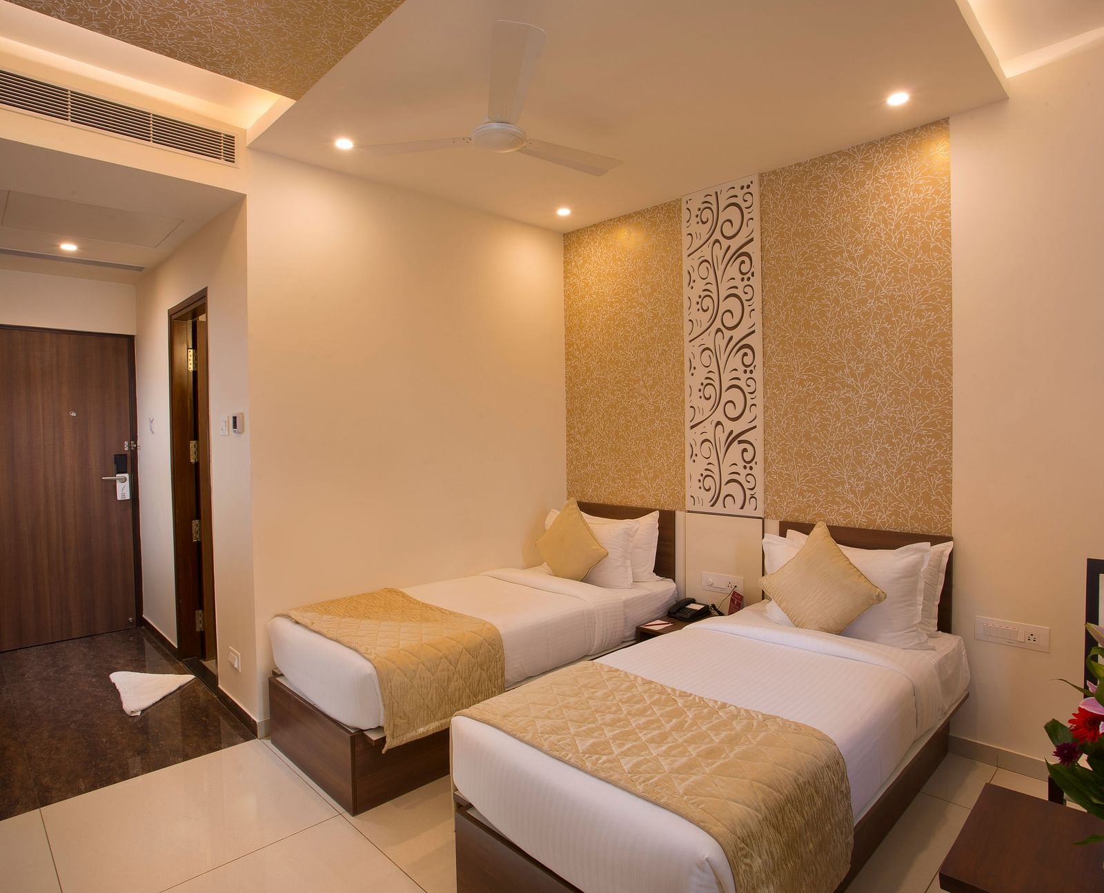 A hotel room with two single beds, patterned wallpaper and a warm, inviting decor - De Venetian by TGI, Brookefield