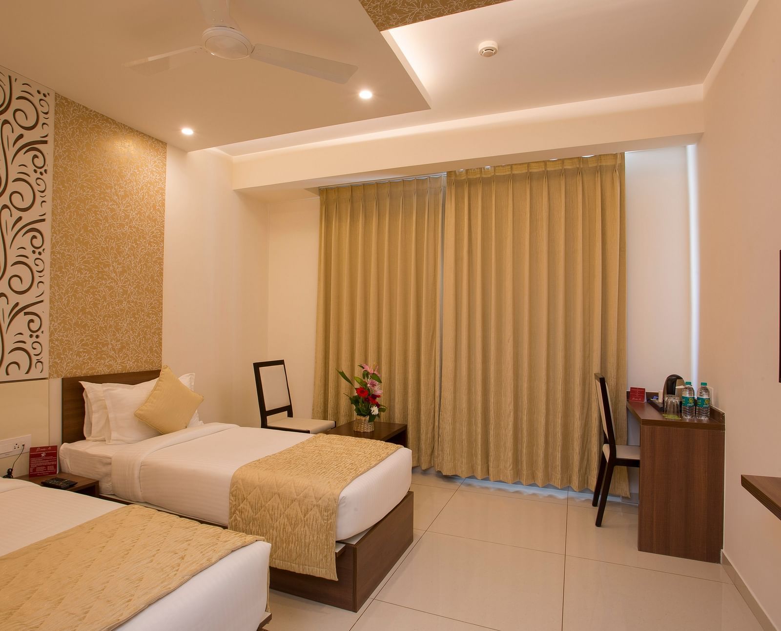 A spacious hotel room with modern amenities, twin beds and decorative wallpaper - De Venetian by TGI, Brookefield