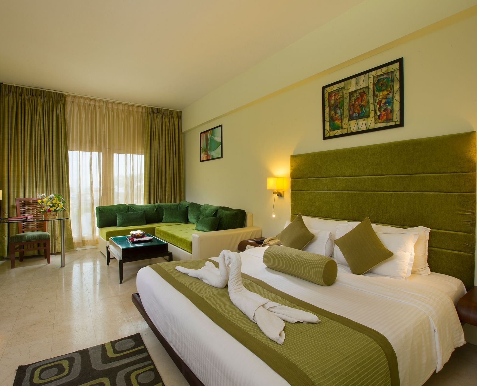 Family suite featuring a bed, a sofa and recliner at Hotel Atithi - TGI Grand, Pondicherry
