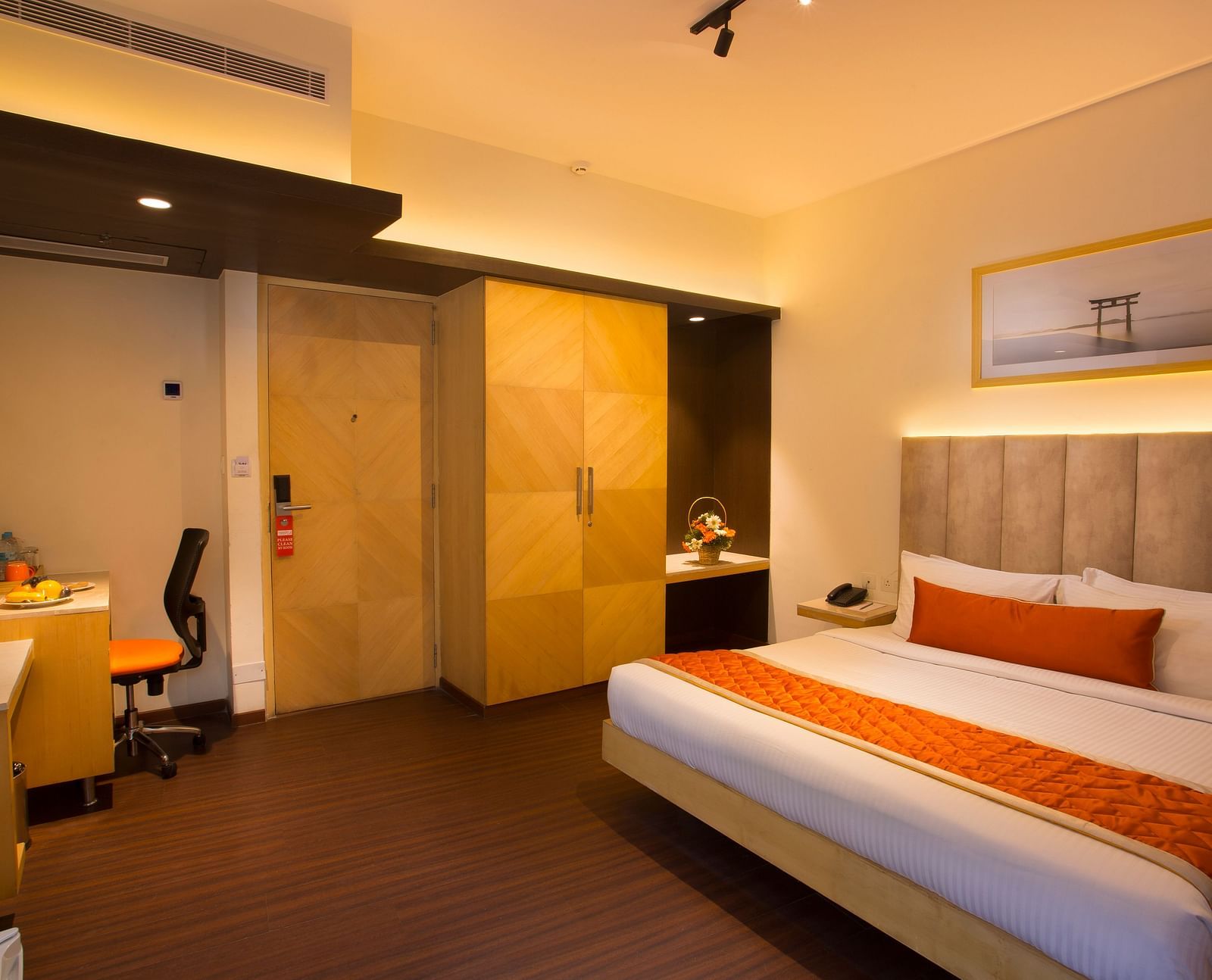 A spacious hotel room with a comfortable bed, ambient lighting and a television, featuring a wooden wardrobe and desk - Hotel Langford Keys by TGI, Shanti Nagar