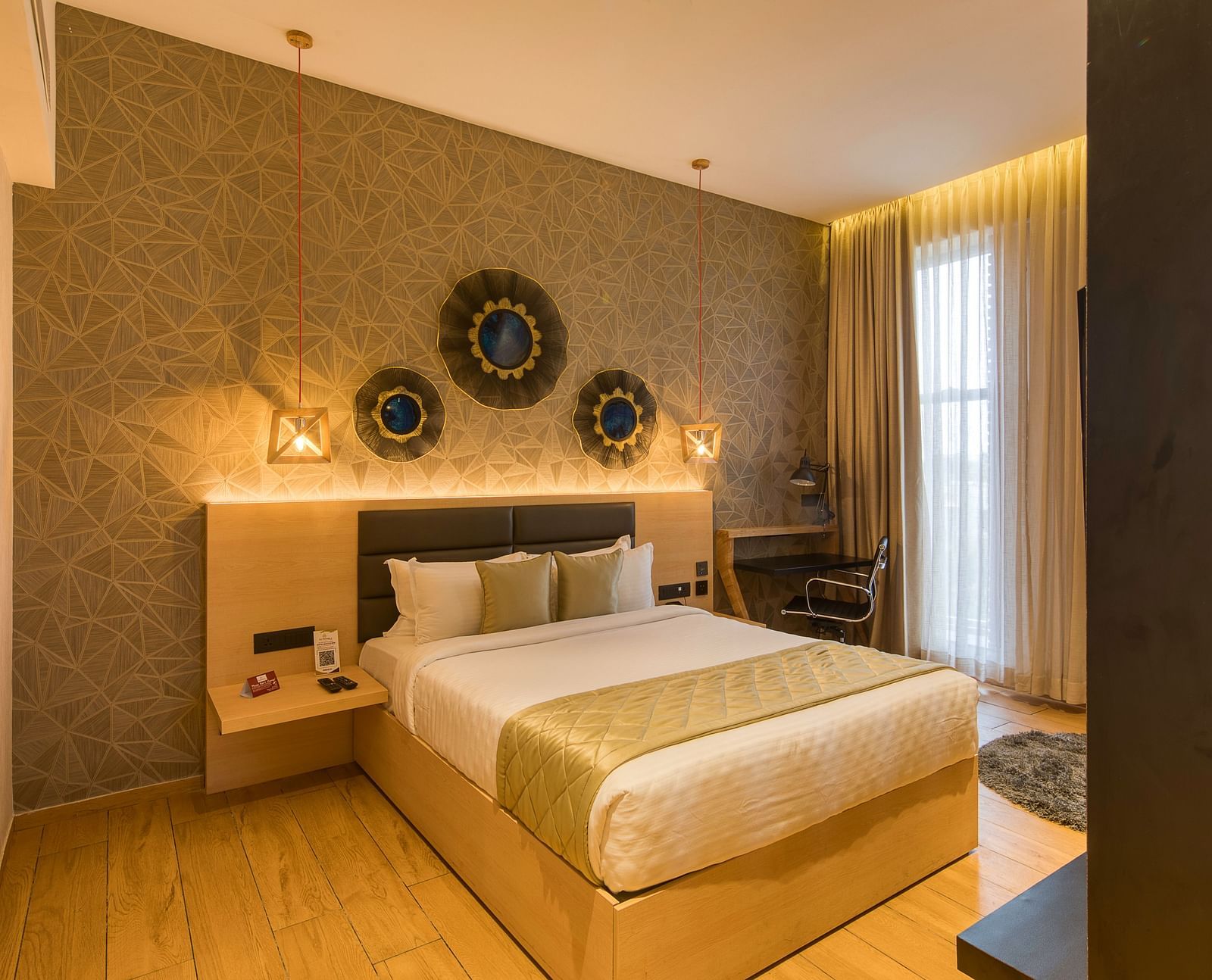 A double bed with golden bedsheets at Sumo Suite at Le Foliage by TGI, Bangalore