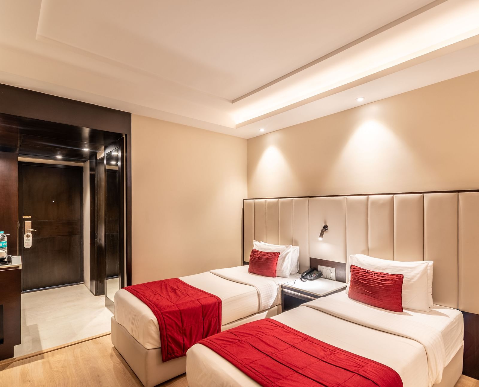 Superior Room with two beds featuring patterned bedding, a desk area, and lighting- TGI Grand Fortuna, Krishnagiri Main Road, Hosur