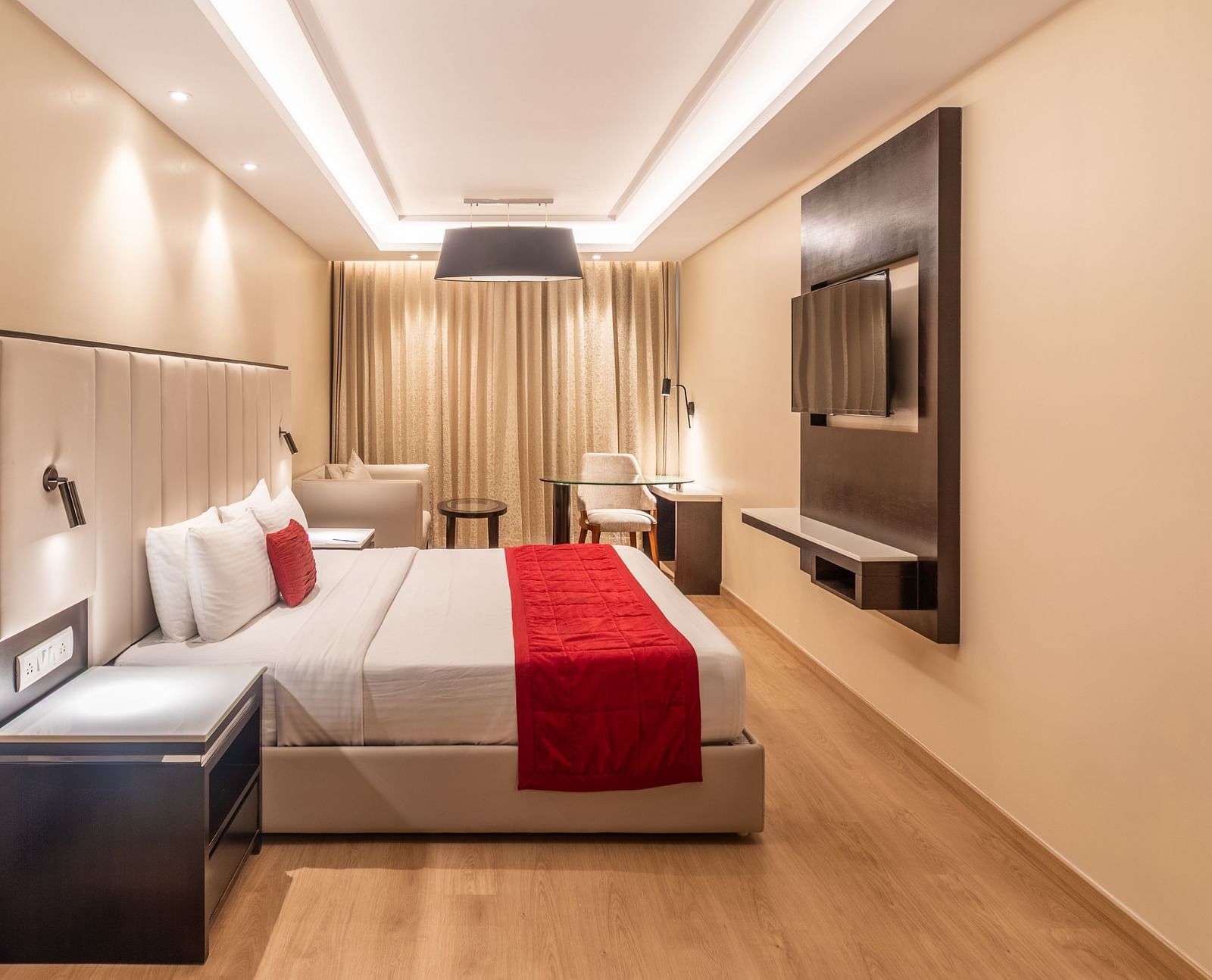 Cozy double room featuring a red runner and a flat-screen TV of Grand Suite- TGI Grand Fortuna, Krishnagiri Main Road, Hosur