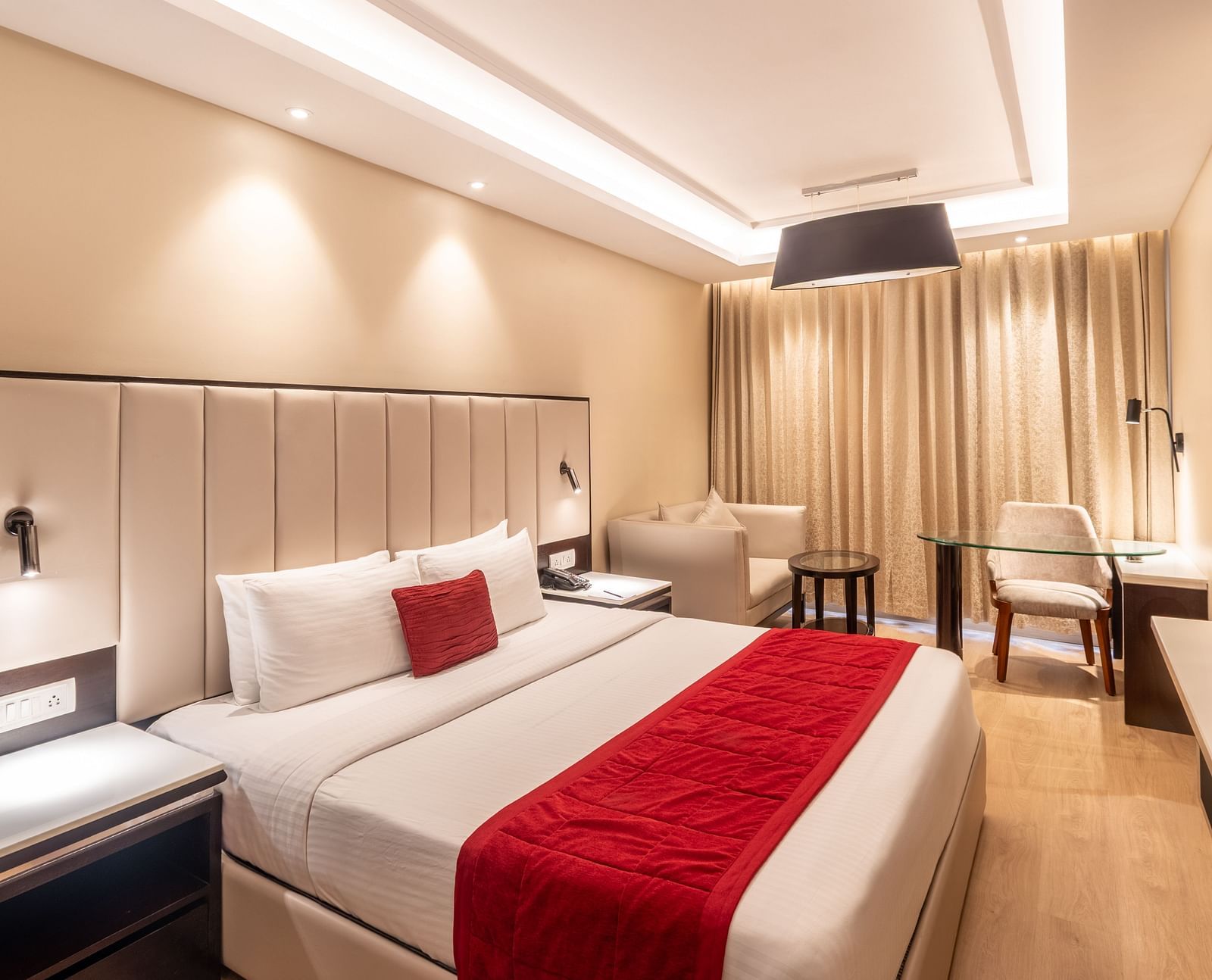 Grand Suite with a huge bed, red accents, and soft ambient lighting,- TGI Grand Fortuna, Krishnagiri Main Road, Hosur