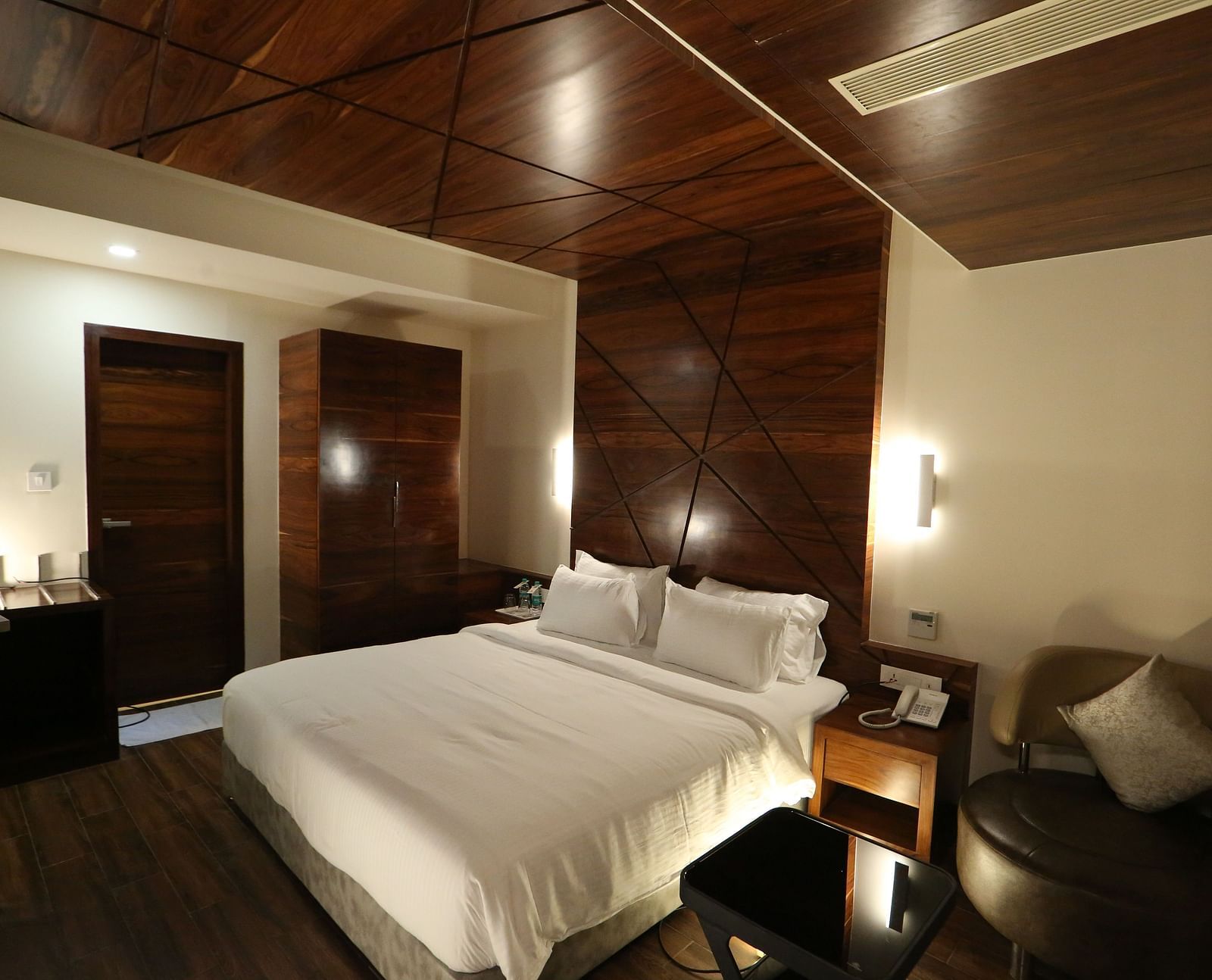 Premium Suite featuring a king size bed and bedside tables. - TGI SPS Grand, Coimbatore