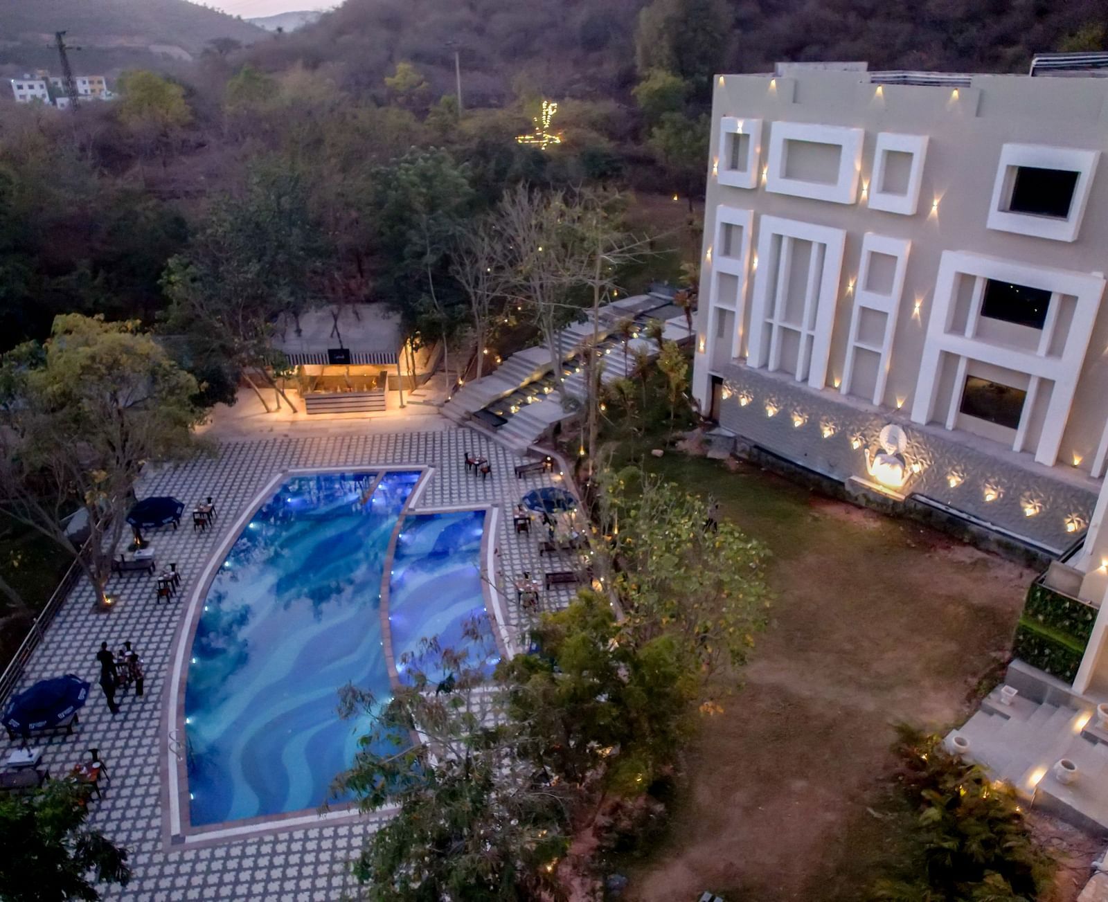 Aerial view of the swimming pool at Essentia Luxury Resort & Spa, Udaipur.