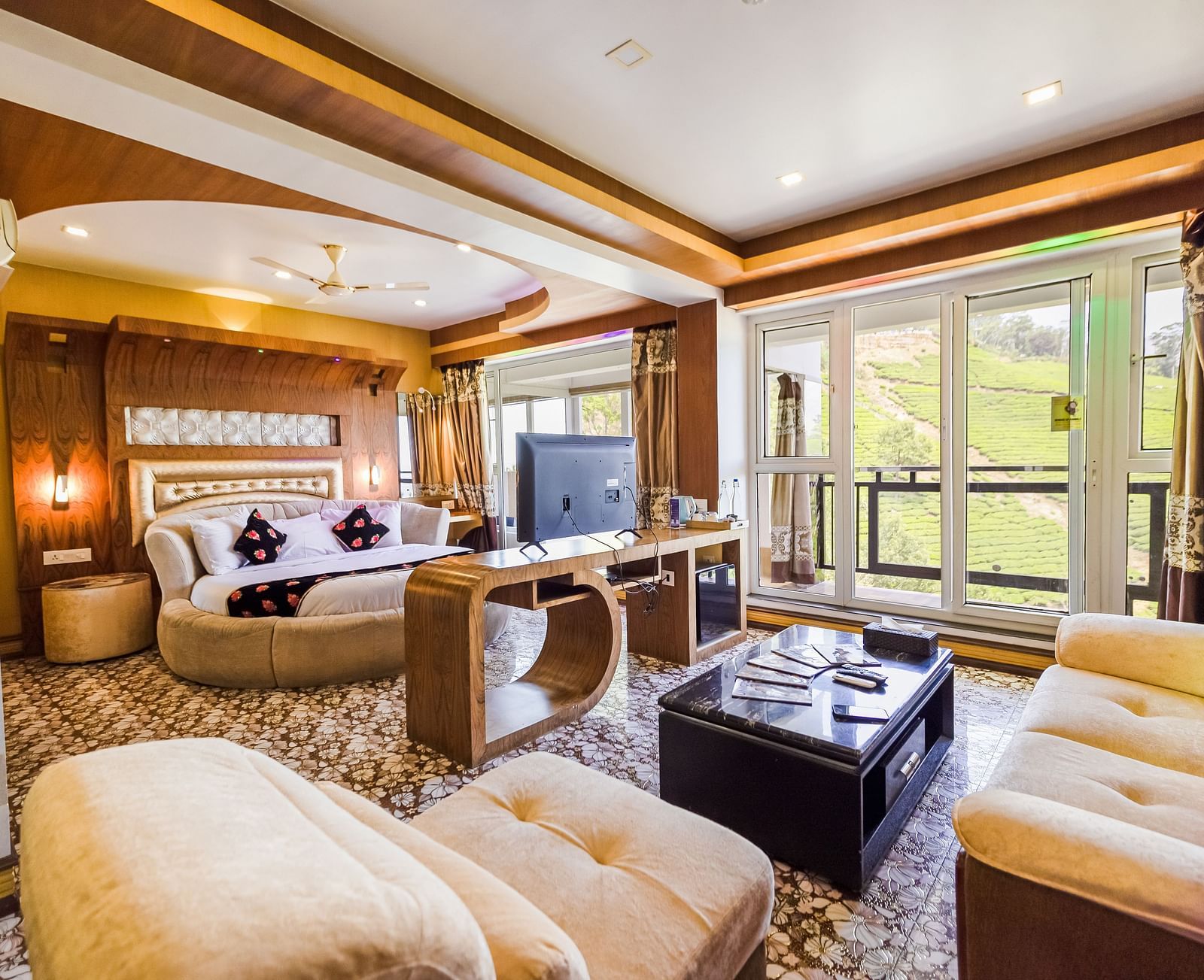 A living area and a round bed in the Honeymoon Suite at Parakkat Nature Hotel and Resorts Munnar 2