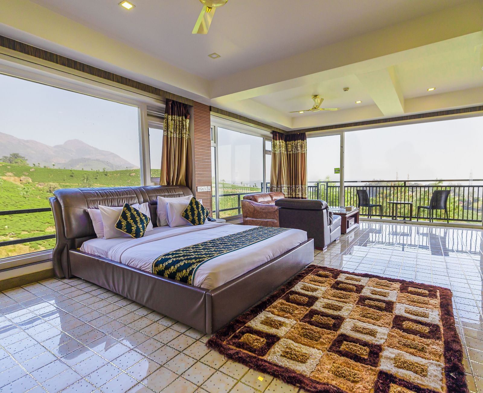 A double bed with 180 degree view of the plantation in the 180 Degree Club Suite at Parakkat Nature Hotel and Resorts Munnar 2
