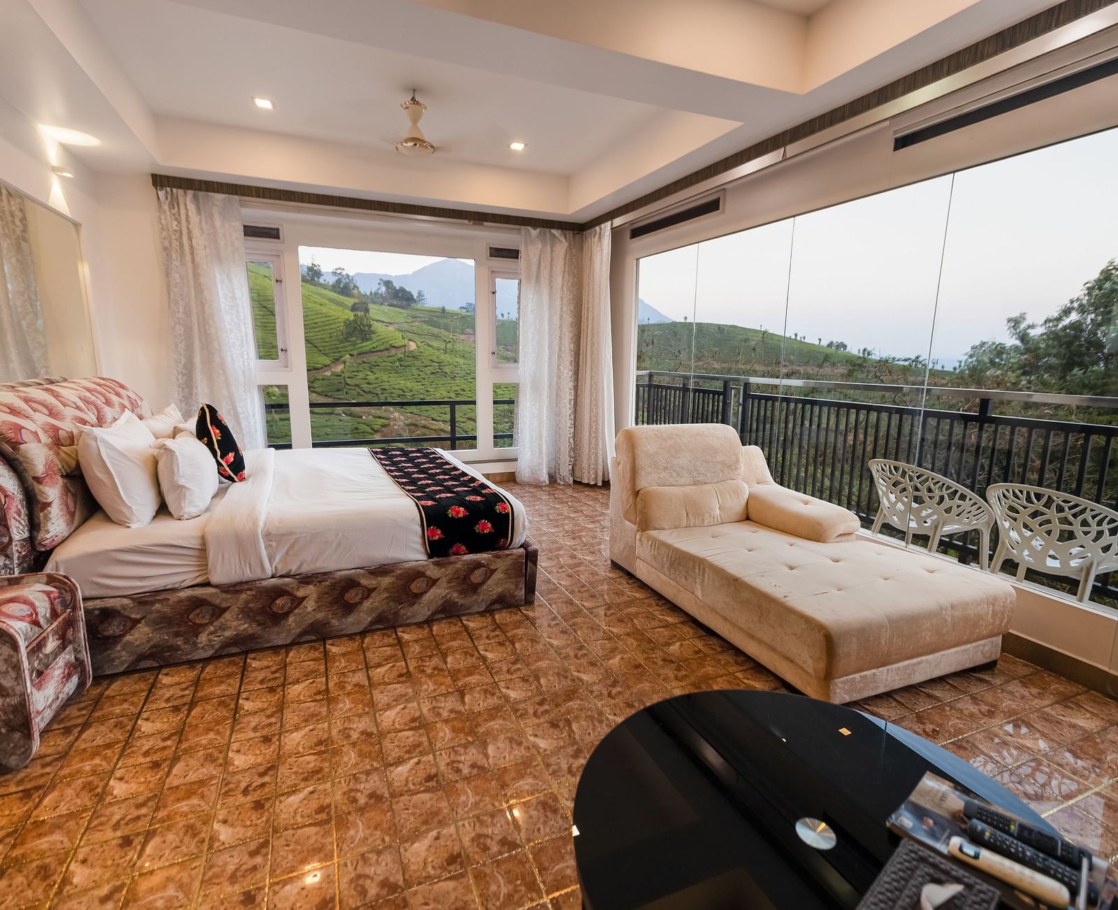 Side view of the bed and sofas at the Family Interconnected Club Suite Parakkat Nature Hotel and Resorts Munnar 1