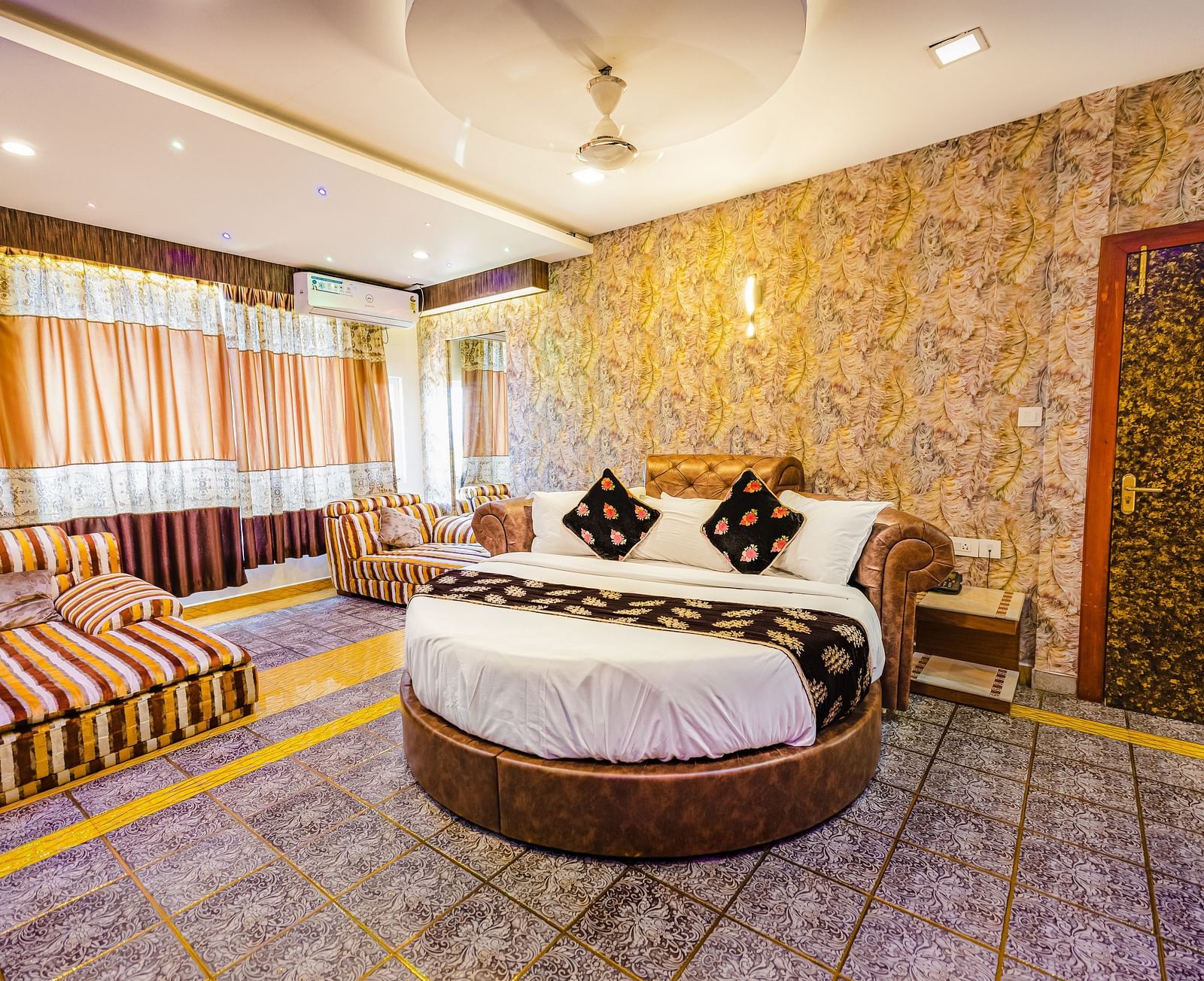 A round bed and sofa in the Jacuzzi Family Room at Parakkat Nature Hotel and Resorts Munnar 2
