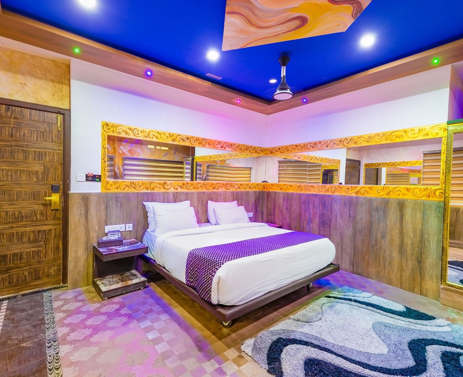 Side view of the double bed with blue ceiling in the Jungle Room at Parakkat Nature Hotel and Resorts Munnar 3