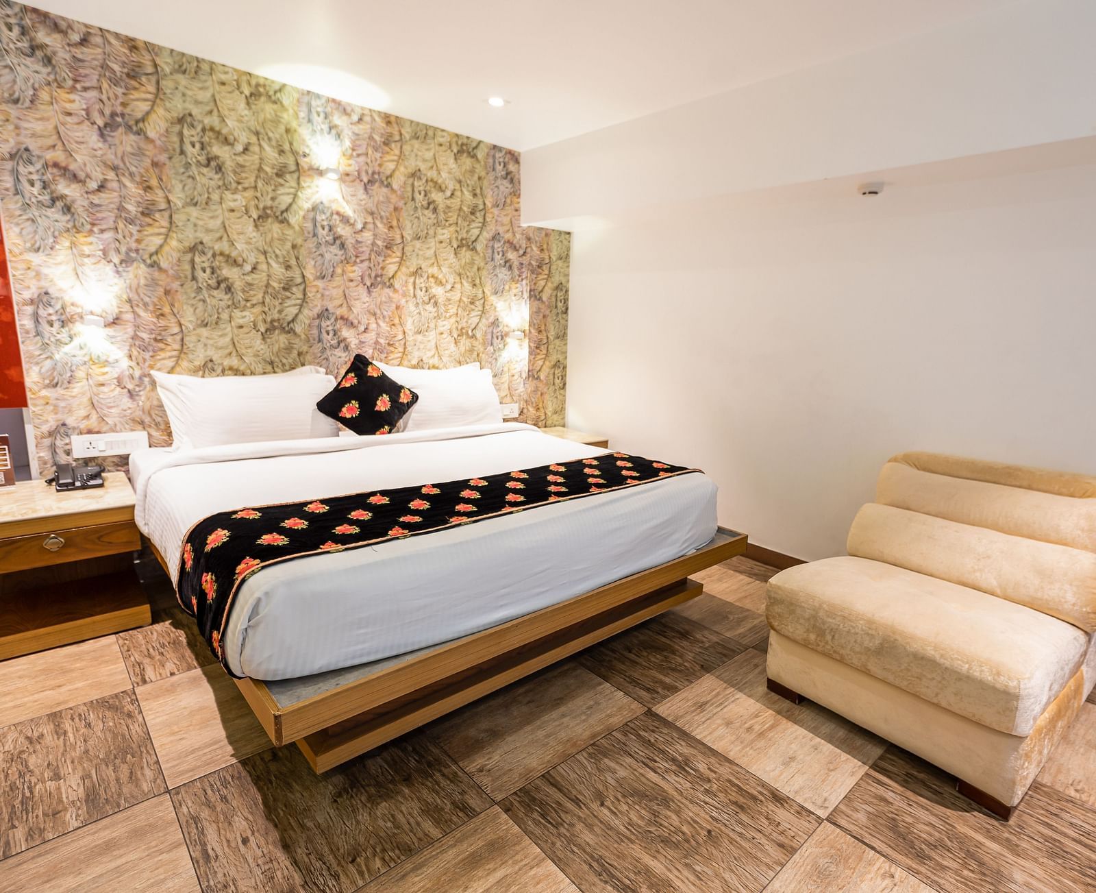 wide view of a double bed and a single sofa in the Premium Room at Parakkat Nature Hotel and Resorts Munnar 2